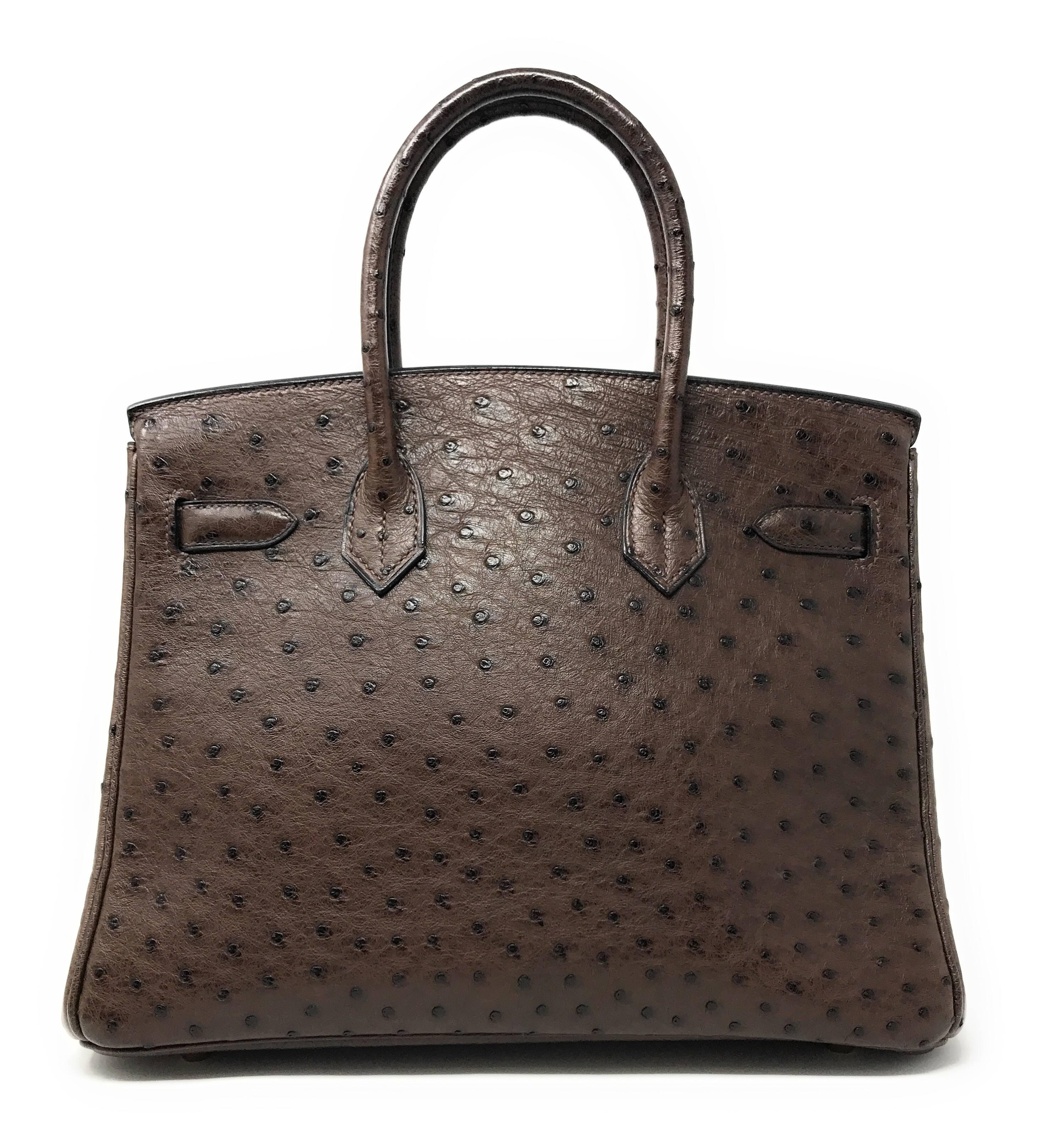 Better than chocolate! This 30cm dark Chocolate Brown Birkin is crafted in Ostrich skin which was discontinued by Hermes for a while making it an extremely hard to to get luxury item. 
Pores are visible throughout the exterior creating a chic and