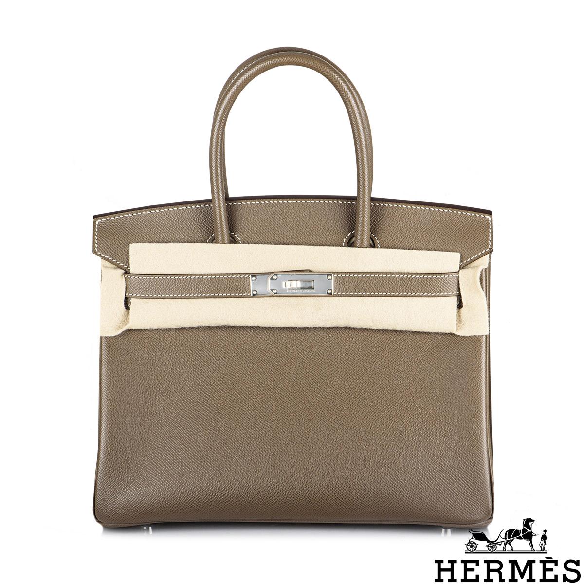 A classic Hermès 30cm Birkin bag. The exterior of this Birkin is in Etoupe Veau Epsom leather with white stitching. It features palladium hardware with two straps and front toggle closure. The interior has a zip pocket with an Hermès engraved zipper