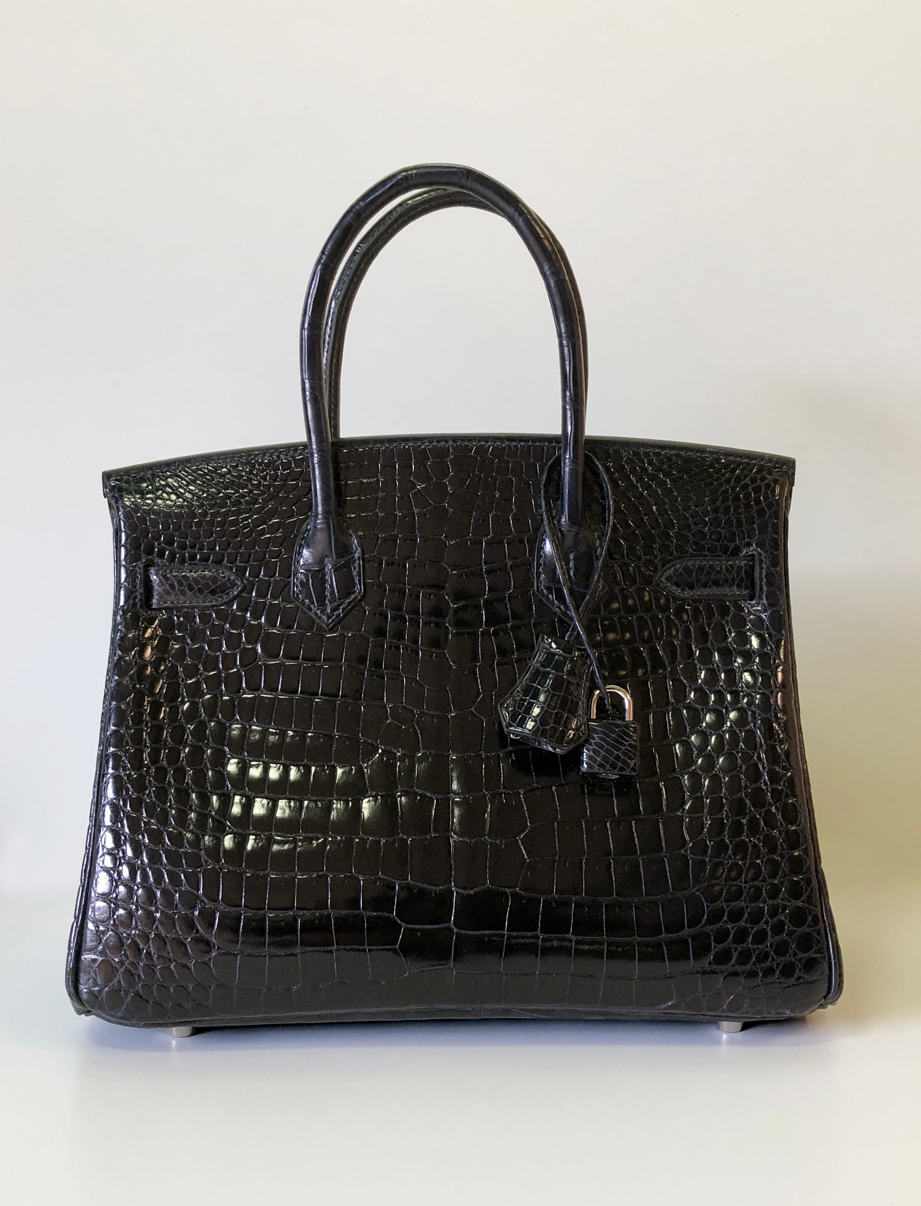 This Hermes Birkin 30 combines the deep and powerful shade of Blue Marine with the luxurious effect of the highest grade shiny porous crocodile, offset with silver palladium hardware.
Presented with the lock and keys in the clochette, sleepers,
