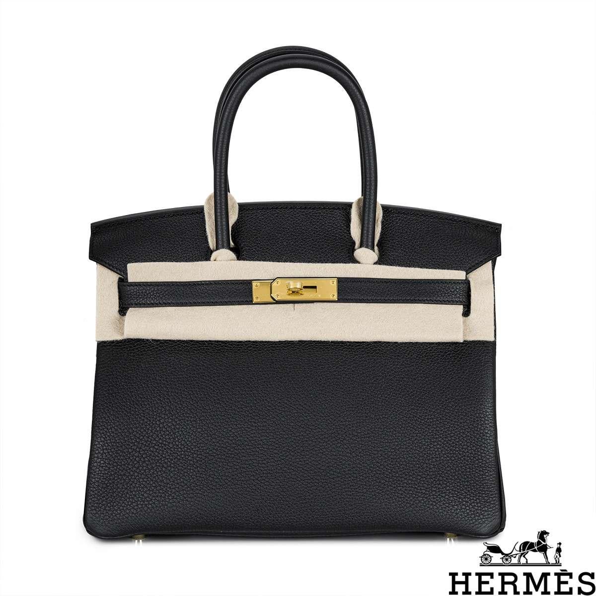 An amazing Hermès 30cm Birkin bag. The exterior of this Birkin is in Noir Veau Togo leather with tonal stitching. It features gold tone hardware with two straps and front toggle closure. The interior features a zip pocket with an Hermès engraved 