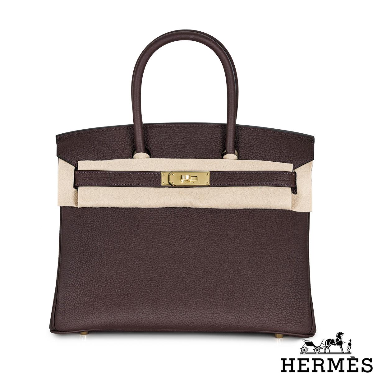 An amazing Hermès 30cm Birkin bag. The exterior of this Birkin is in Rogue Sellier Togo leather with tonal stitching. It features gold tone hardware with two straps and a front toggle closure. The interior features a zip pocket with an Hermès