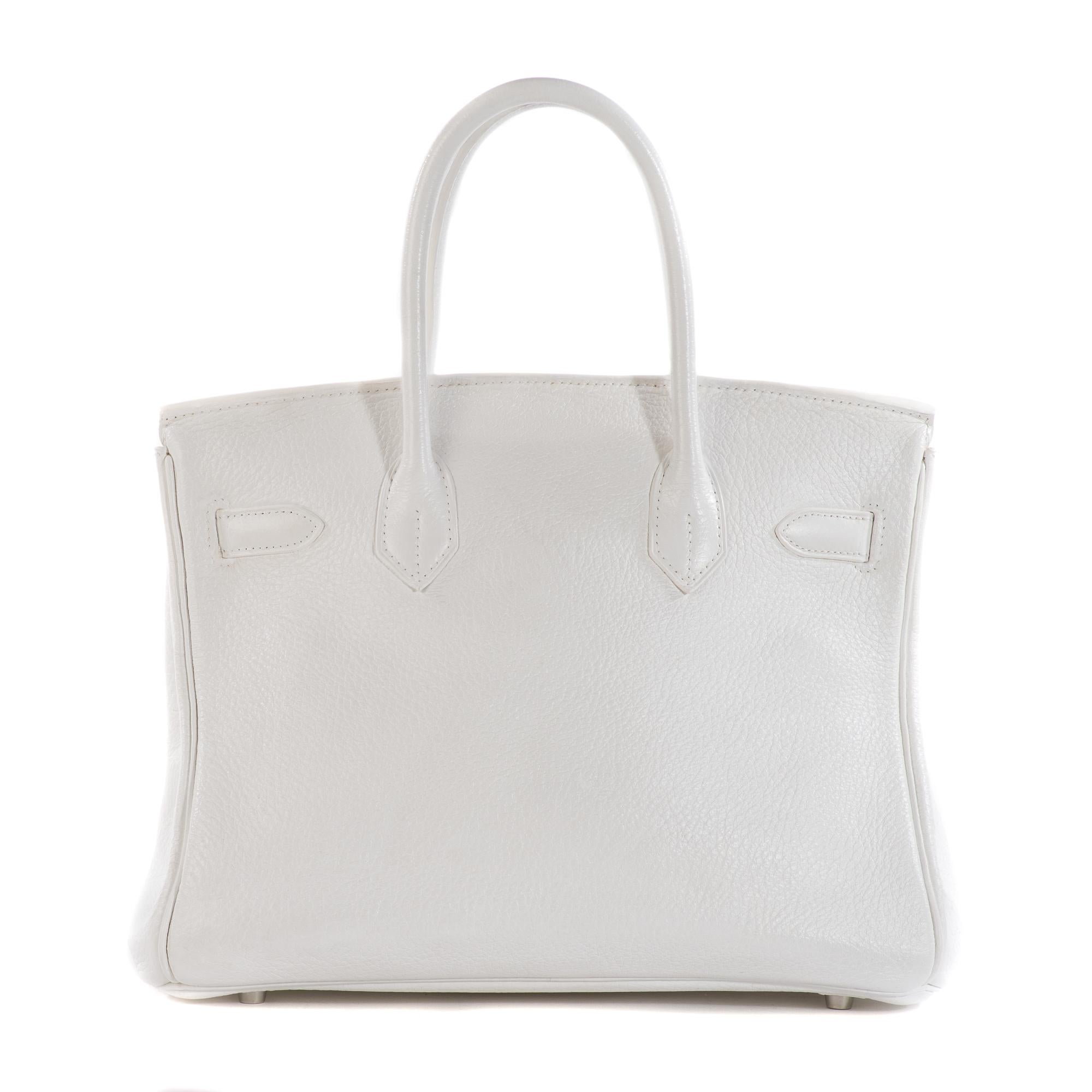 The iconic Hermes Birkin 30 cm handbag in white togo leather, palladium metal hardware, double gold leather handle for hand carrying.

Inner lining in gold leather, a zipped pocket, a patch pocket.
Sold with zipper, key, padlock, bell.
Signature: