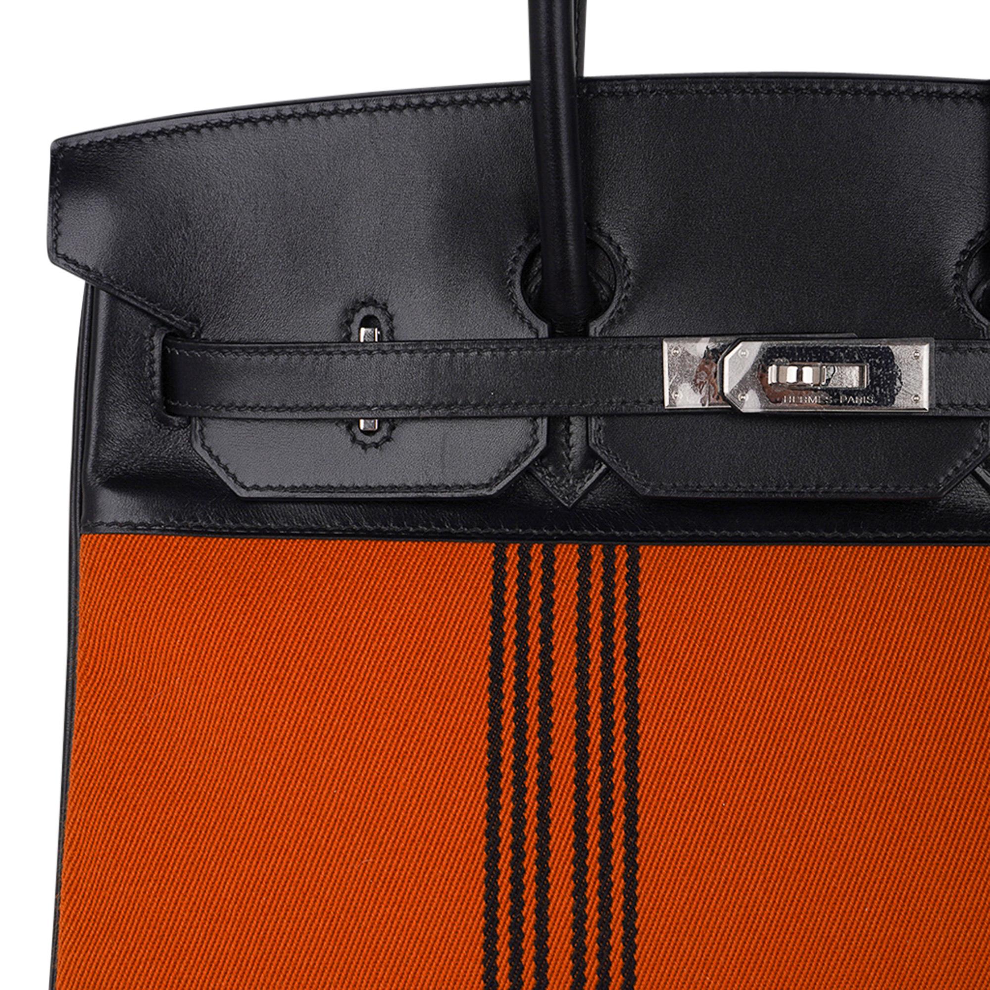 Mightychic offers a very rare Limited Edition Hermes 35 Birkin Potamus featured in Orange canvas and Black Box leather.
The rich Orange body features 7 Black vertical lines.
Crest, corners, sides and handles are polished Box leather.
A modern take