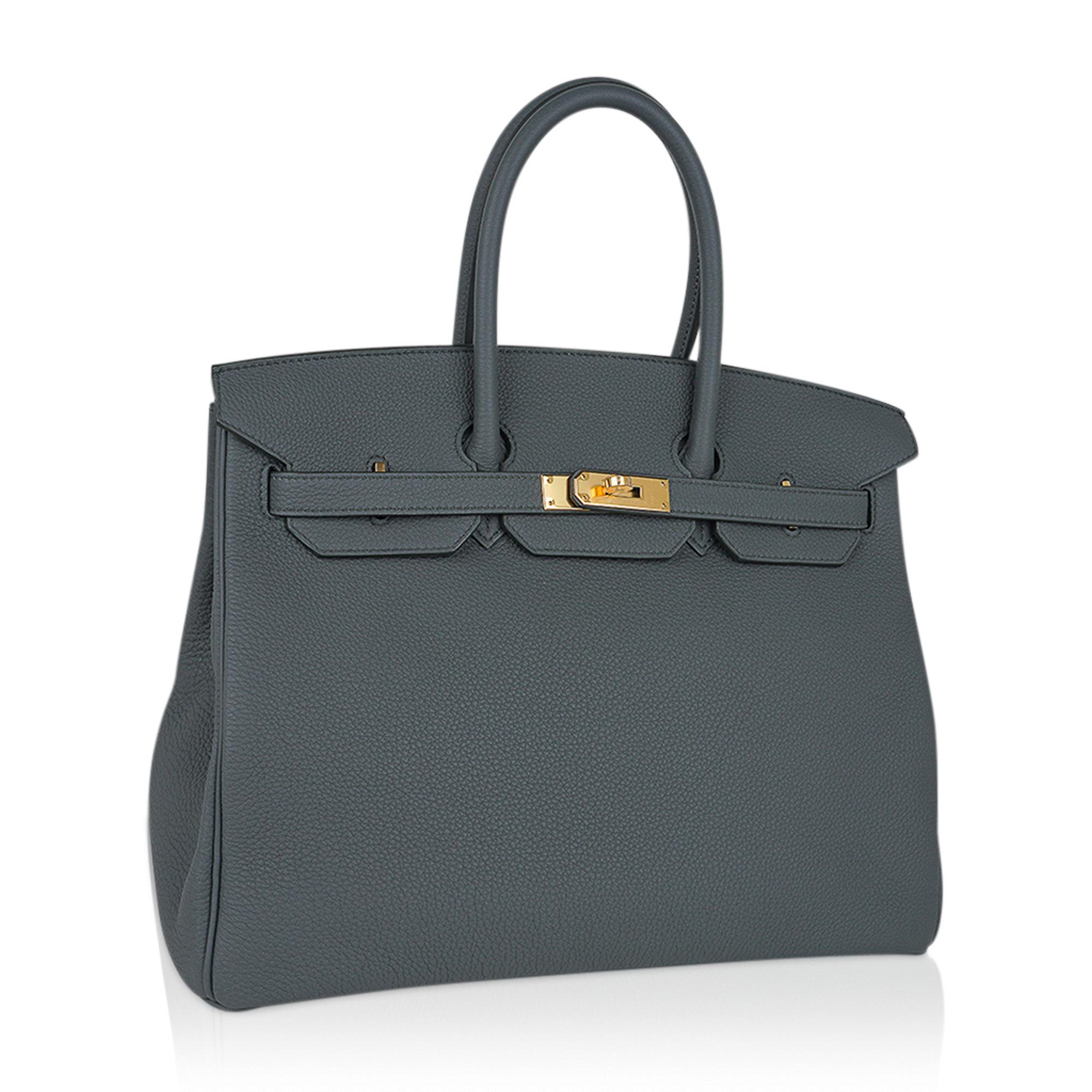 Mightychic offers an Hermes Birkin 35 bag featured in gorgeous Vert Amande.
A beautiful muted green-gray-tone makes this a fabulous neutral Birkin bag.
Rich and timeless with gold hardware.
Togo leather is textured and resistant to scratches.
Comes