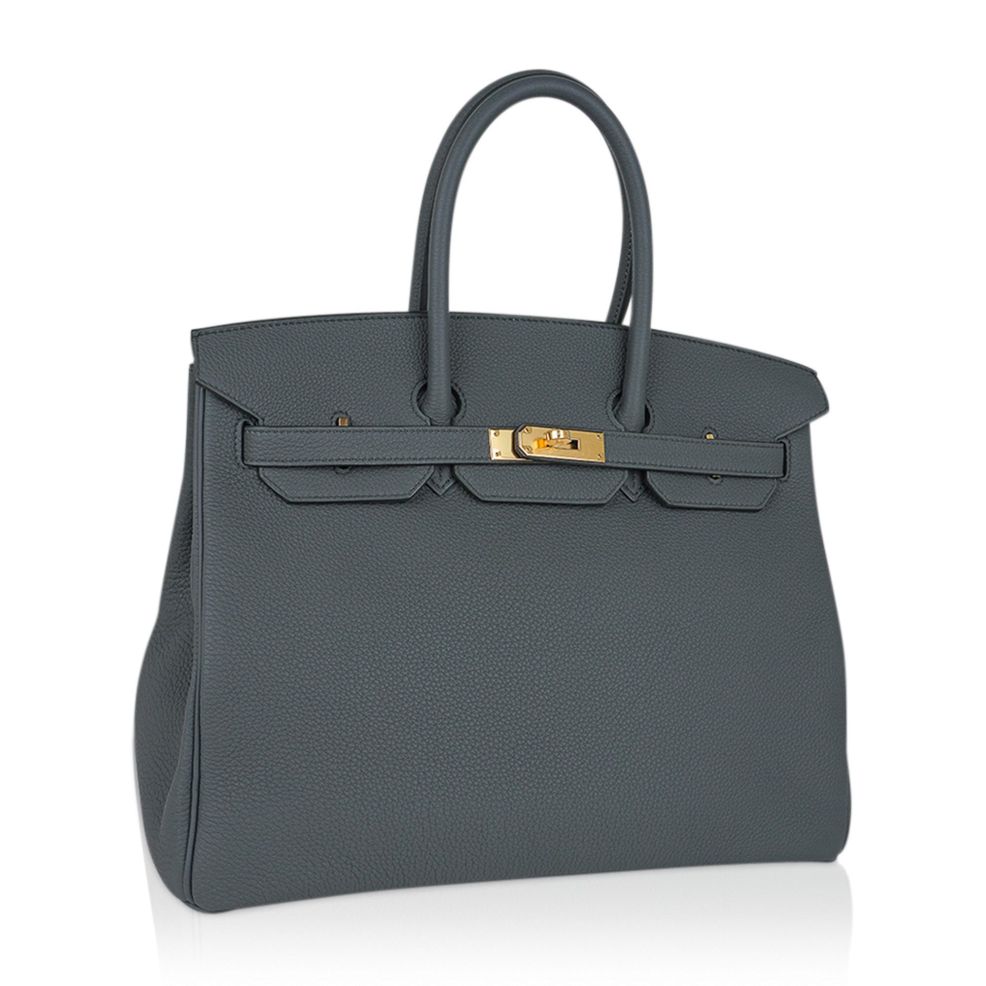 Mightychic offers an Hermes Birkin 35 bag featured in gorgeous Vert Amande.
A beautiful muted green-gray-tone makes this a fabulous neutral Birkin bag.
Rich and timeless with gold hardware.
Togo leather is textured and resistant to scratches.
Comes