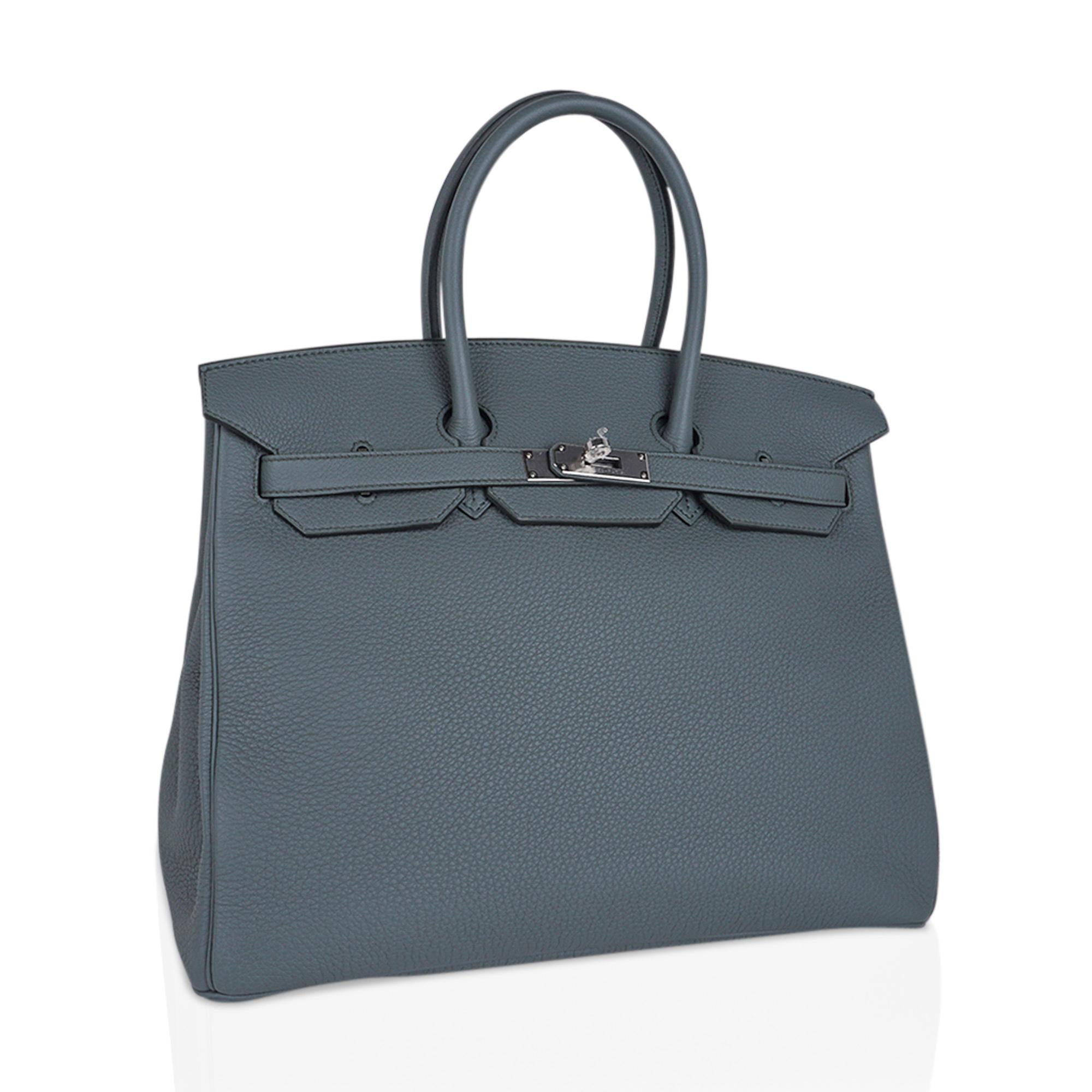 Mightychic offers an Hermes Birkin 35 bag featured in gorgeous Vert Amande.
A beautiful muted green-gray-tone makes this a fabulous neutral Birkin bag.
Fresh with palladium hardware.
Togo leather is textured and resistant to scratches.
Comes with