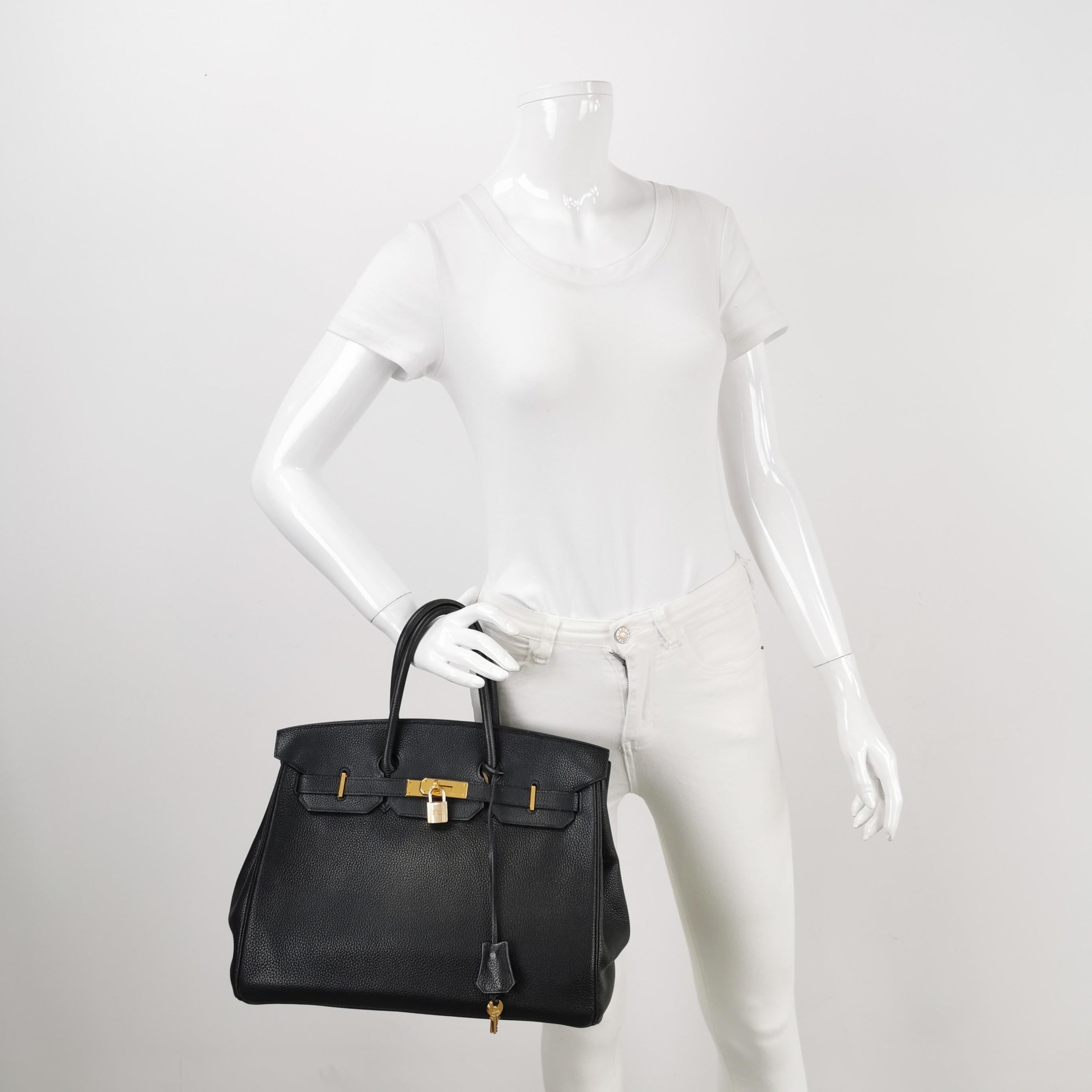 Condition: Good condition.

Overall signs of use. Scratches on leather and hardware. Light stains on the inside. Rubbing on the corners, handles, wax on the edges. Leather creases. The clochette has fallen apart. The bag has lost its structure and