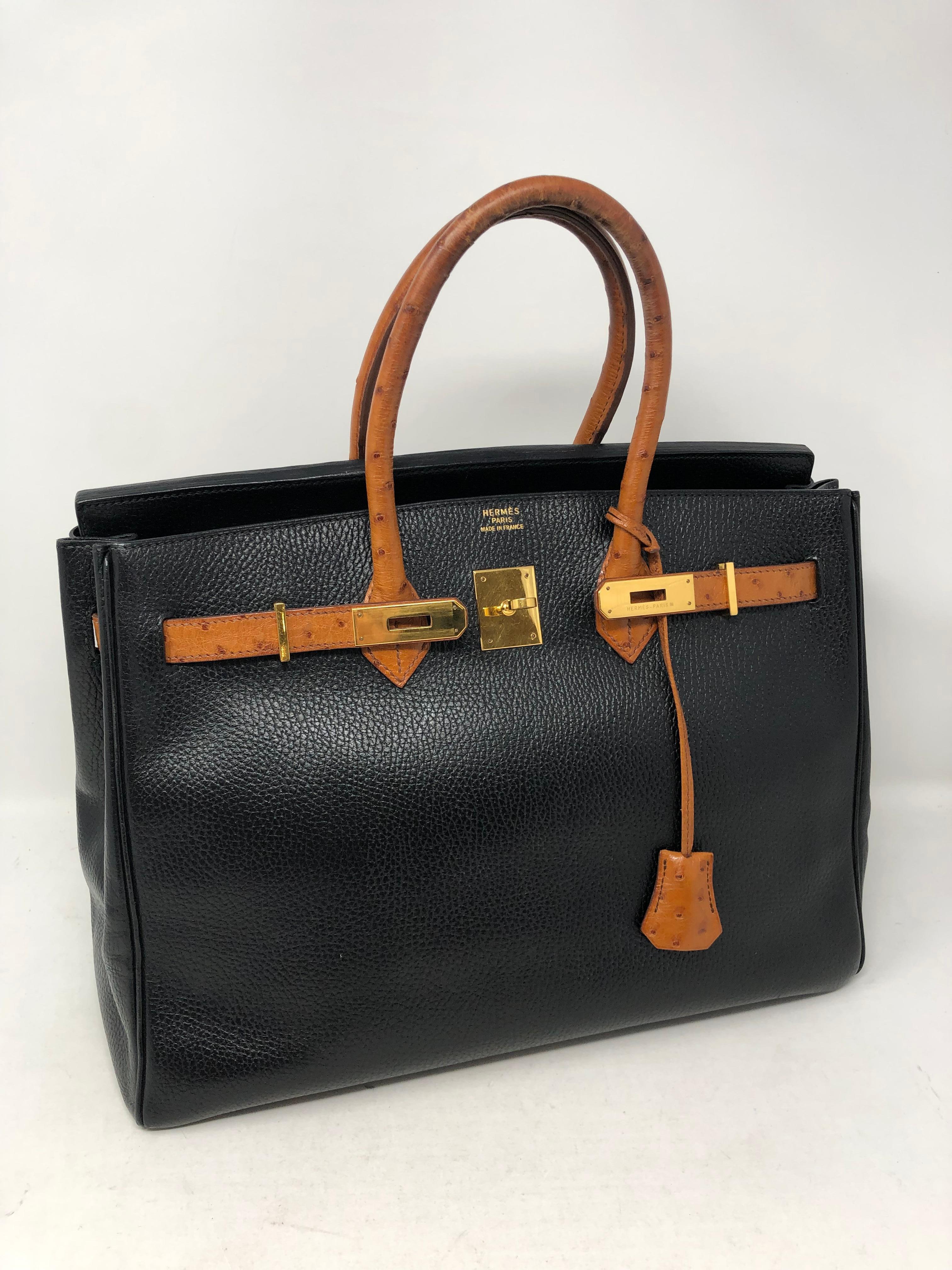 Hermes Birkin 35 Black with Ostrich Leather Handles and Trim. Gold hardware. Vintage from 1995. Rare Birkin. A beautiful and unique piece that is hard to find. Black leather in great condition. The ostrich handles have some wear and can be reglazed