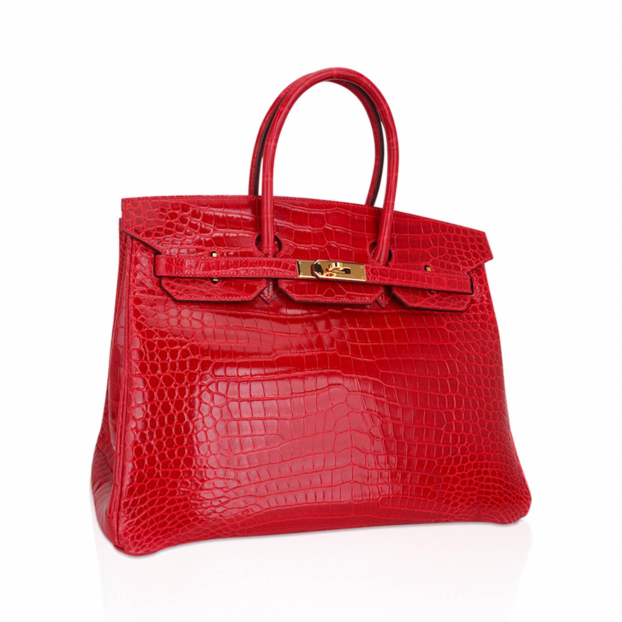 Mightychic offers an Hermes Birkin 35 coveted rare Braise fire engine lipstick red bag.
Porosus Crocodile is the most rare and exclusive Hermes skin.  The most beautiful small scales.
Rarely produced this exquisite Hermes red crocodile Birkin bag is