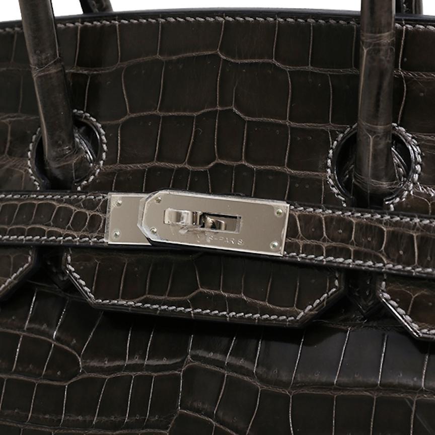 Our Newest Hermes Birkin Has Arrived.   

Featuring shiny exotic crocodile skin leather, this Hermes Birkin 35 is one of the most coveted Birkin from the French fashion house. Featuring stunning palladium hardware, it’s a strikingly beautiful status