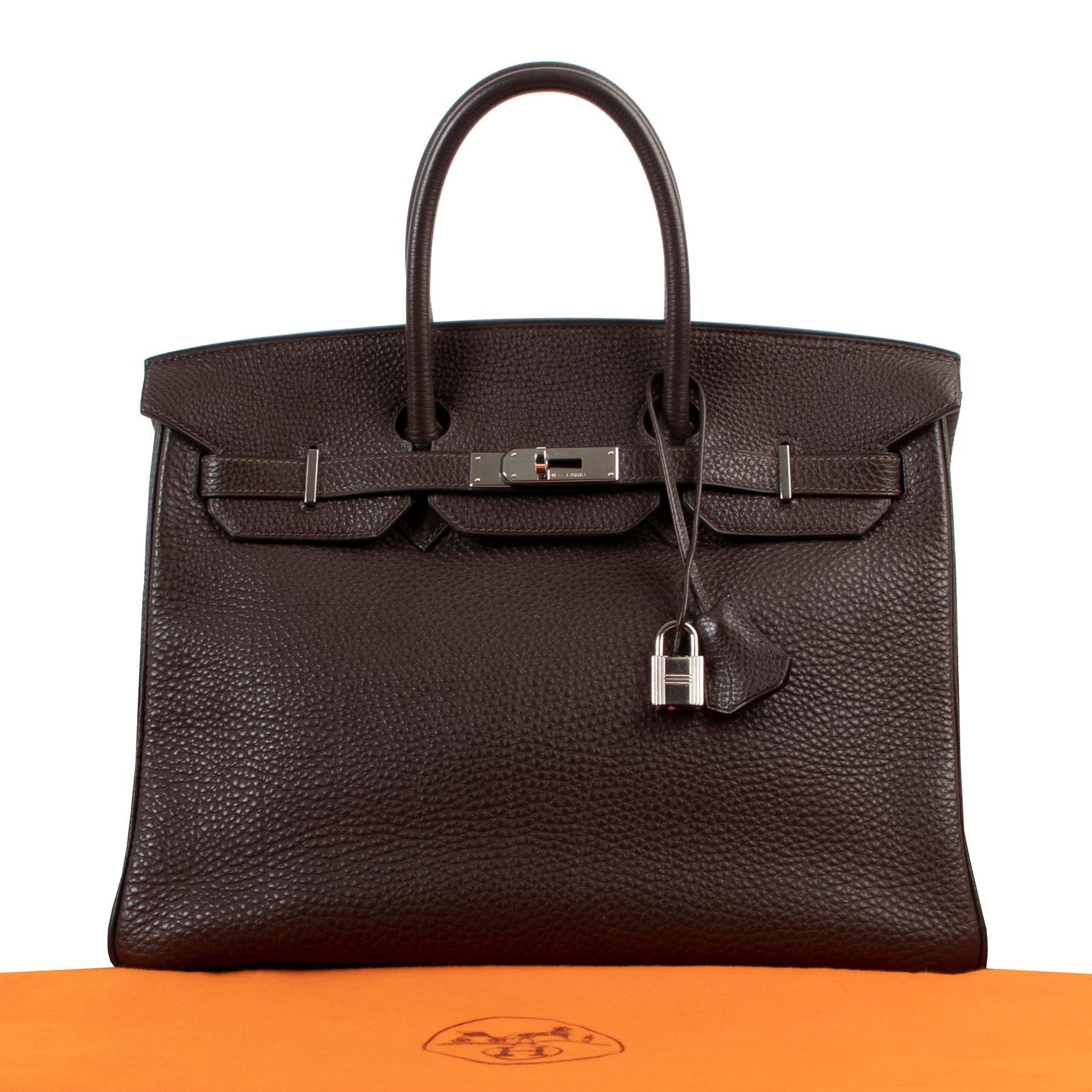 Very Good Condition

Hermès Birkin 35 Ebene Togo PHW

This Hermès Birkin 3cm is handcrafted from scratch-resistant Togo leather in Ebene, a very deep brown shade that perfectly matches this season's neutral colors.  A true classic collector