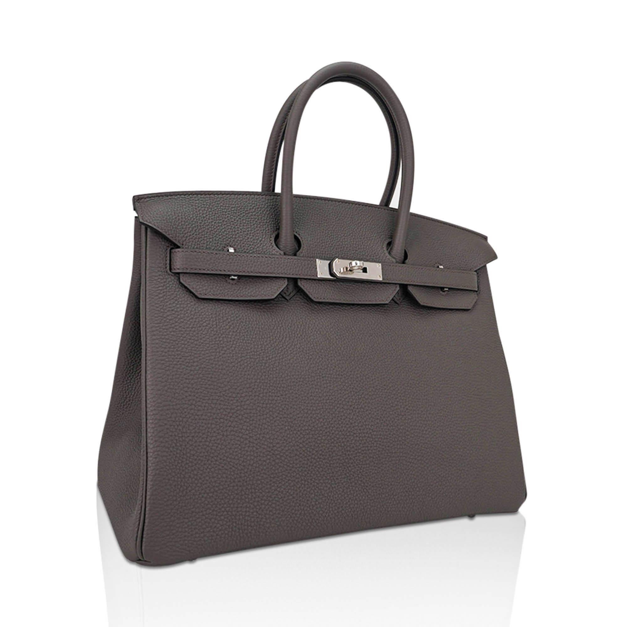 Mightychic offers an Hermes Birkin 35 Etain bag is the most perfect medium gray and is utterly neutral. 
This beauty is absolutely stunning with palladium hardware. 
Clemence leather is textured and highly scratch resistant.
Comes with lock, keys,