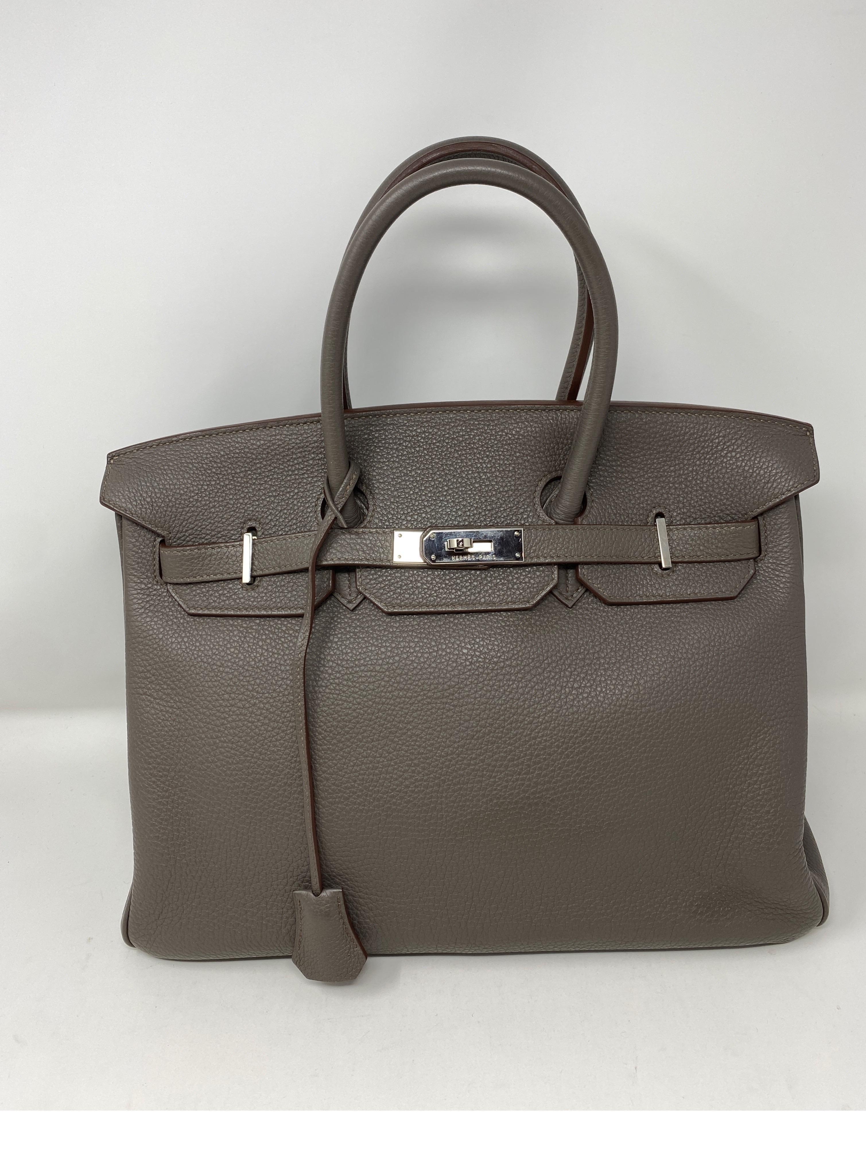 Hermes Etain Birkin 35 Bag. Palladium hardware. Togo leather. Gorgeous darker grey neutral color. Very good condition. Most wanted color. Pairs well with black and other colors. Don't miss out on this one. Includes clochette, lock, keys and dust