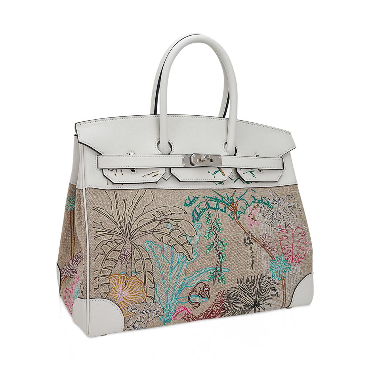 Mightychic offers an Hermes Birkin 35 limited edition bag featured in Faubourg Tropical.
Extremely rare with exquisitely detailed Luneville stitch which took over 200 hours to embroider the textured natural Toile de Camp.
The embroidery flirts with