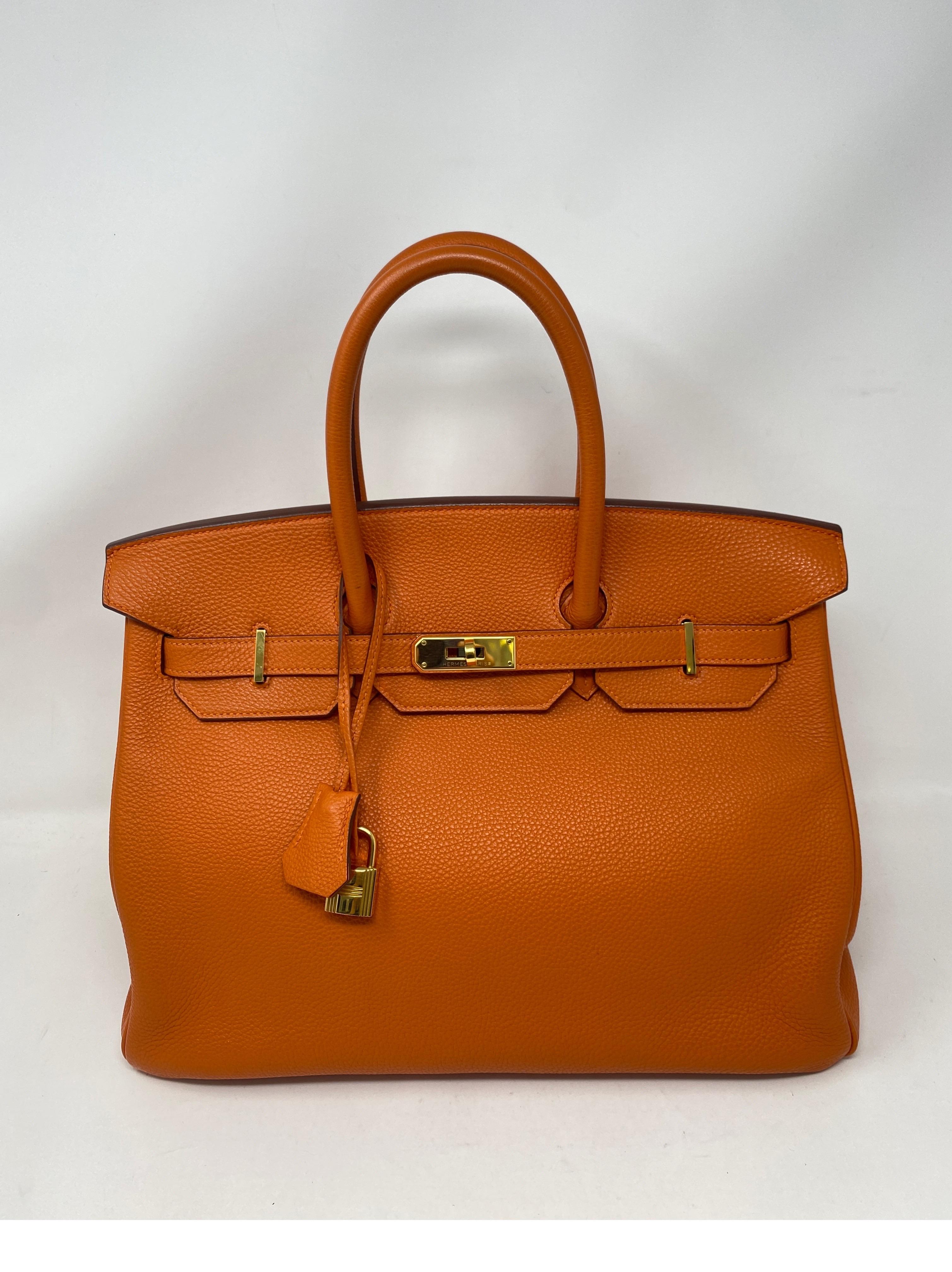 Hermes Birkin 35 Feu Orange Bag. Beautiful vibrant and rare orange color. Gold hardware. Excellent condition. Most wanted combo. Great investment bag. Includes clochette, lock, keys, and dust cover. Guaranteed authentic. 