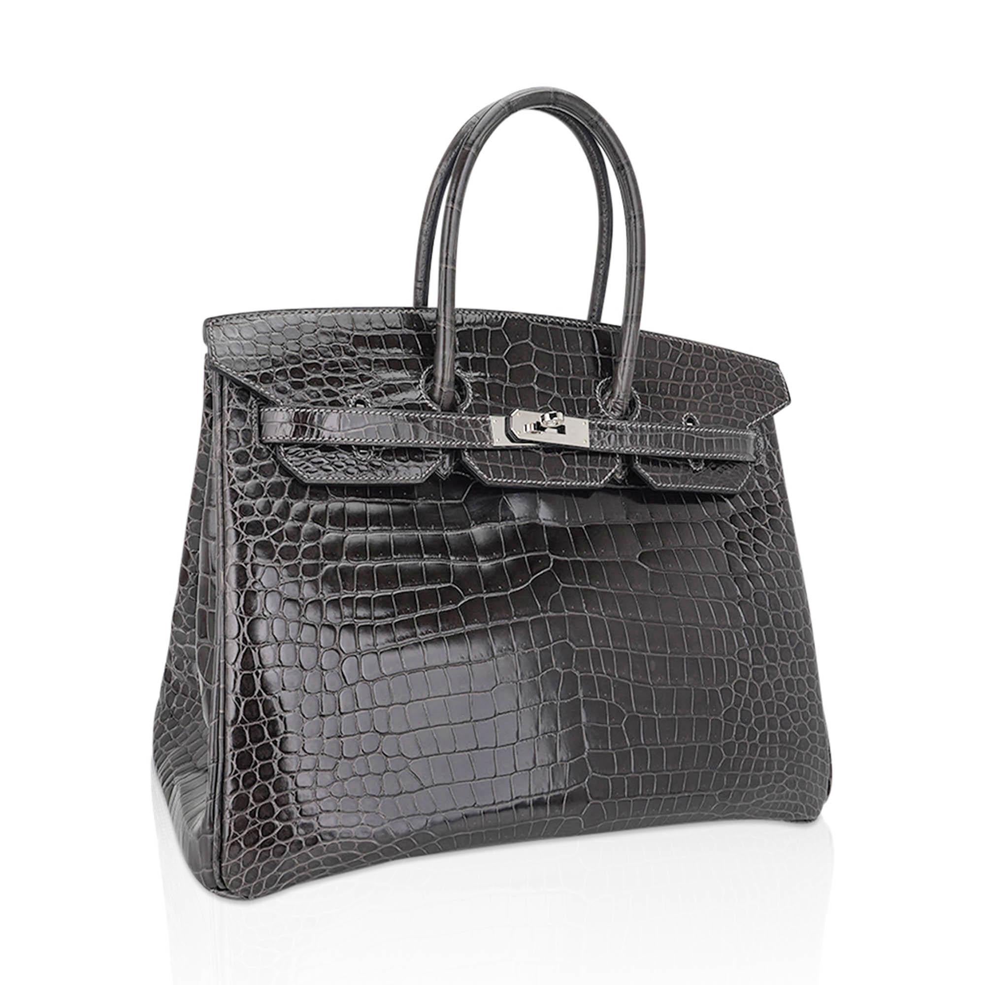 Mightychic offers an Hermes Birkin 35 Bag featured in Graphite porosus crocodile.
This rich neutral is the epitome of sophistication.
Stunning with palladium hardware.
This deep gray Hermes crocodile bag is a magnificent addition to any Hermes