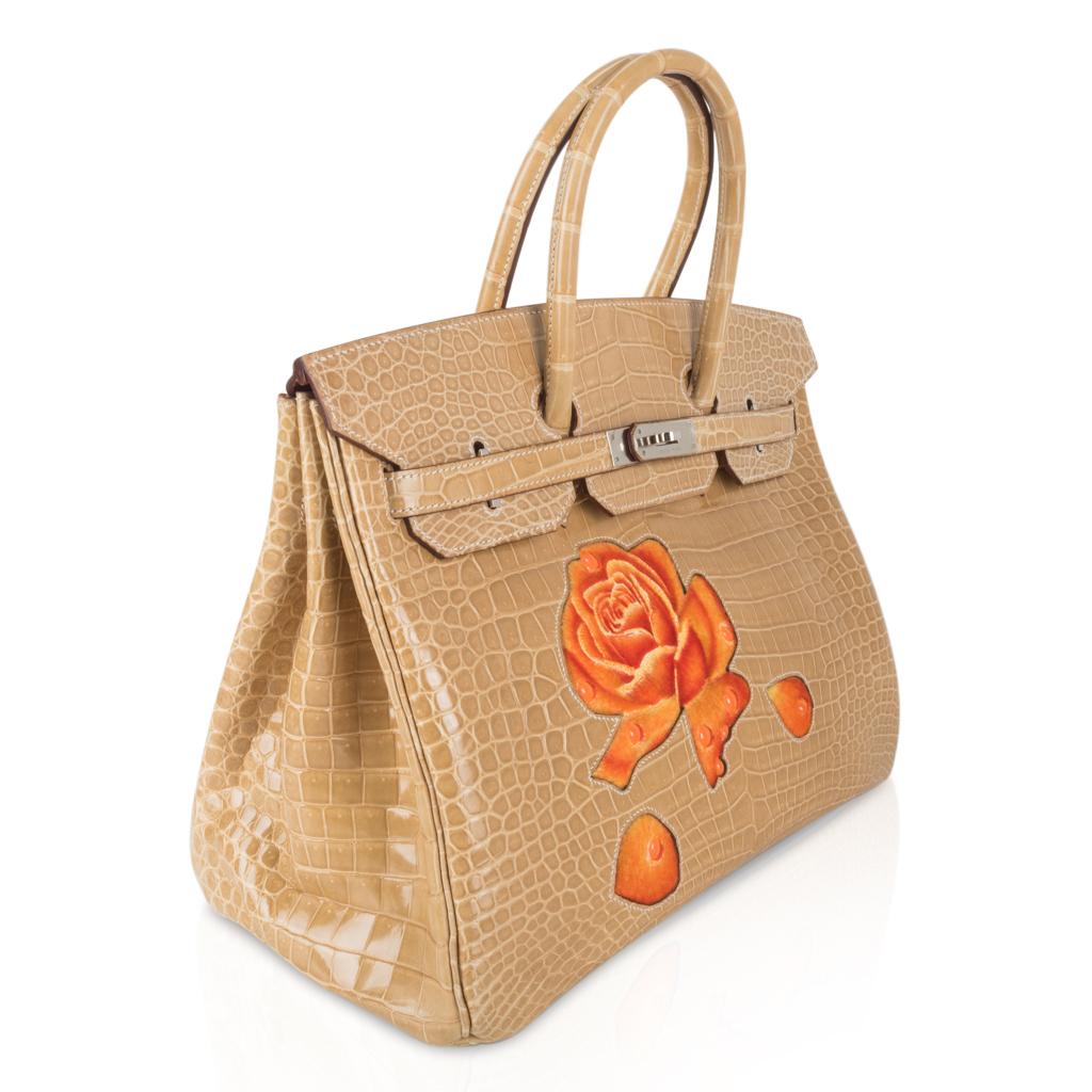Mightychic offers an extraordinary one of a kind Hermes Birkin 35 HSS bag featured in unicorn Poussiere. 
Exquisite neutral no longer produced Poussiere porosus crocodile appliqued with the Dewdrop velvet roses on front.  
This special order Birkin