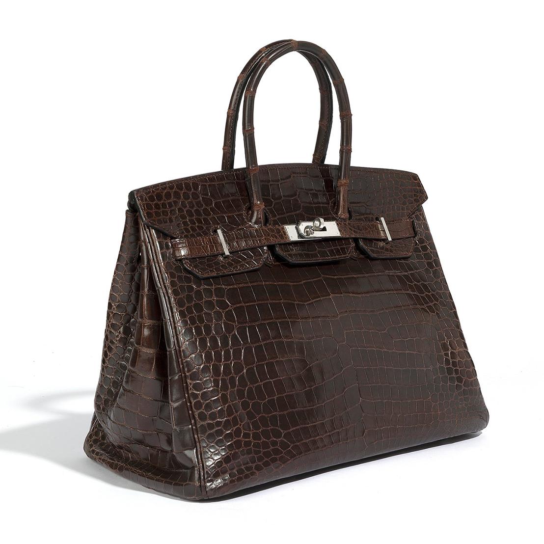 Elevate your style with the timeless elegance of the Hermès Birkin 35 in Marron crocodile leather. This exquisite piece, handcrafted in 2008, features palladium hardware and shows only subtle signs of wear. A luxurious and versatile addition to any