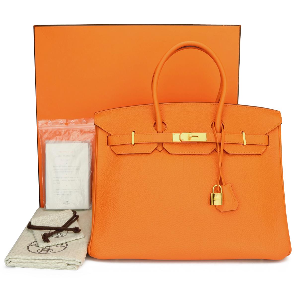 Authentic Hermès Birkin 35cm Orange Togo Leather with Gold Hardware Stamp N Year 2010

This bag is still in mint condition. The bag still holds to the shape well. The hardware still very shiny and covered by the original protective