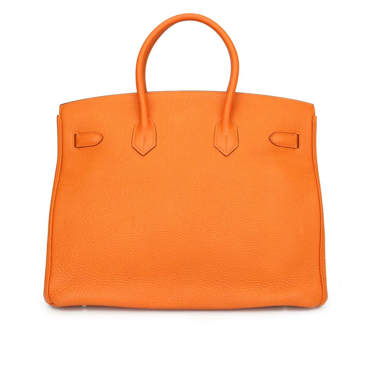 Authentic Hermès Birkin 35cm Orange Togo Leather with Palladium Hardware Stamp N Year 2010

This bag is still in excellent-mint condition. The bag still holds to the shape well. The hardware still very shiny and covered by the original protective