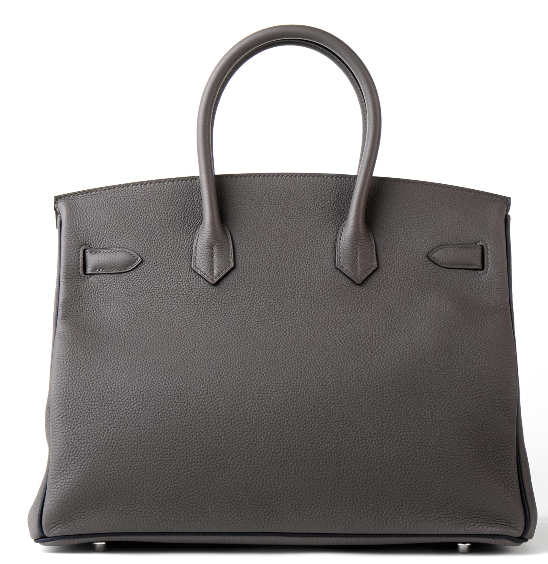 Hermes Special Order horseshoe stamped (HSS) bi-color Etain and Blue Nuit Birkin 35cm of togo leather with palladium hardware.

 

This Gris Etain Birkin has Blue Nuit (dark blue) trim on sides and bottom, tonal stitching,  front toggle closure,