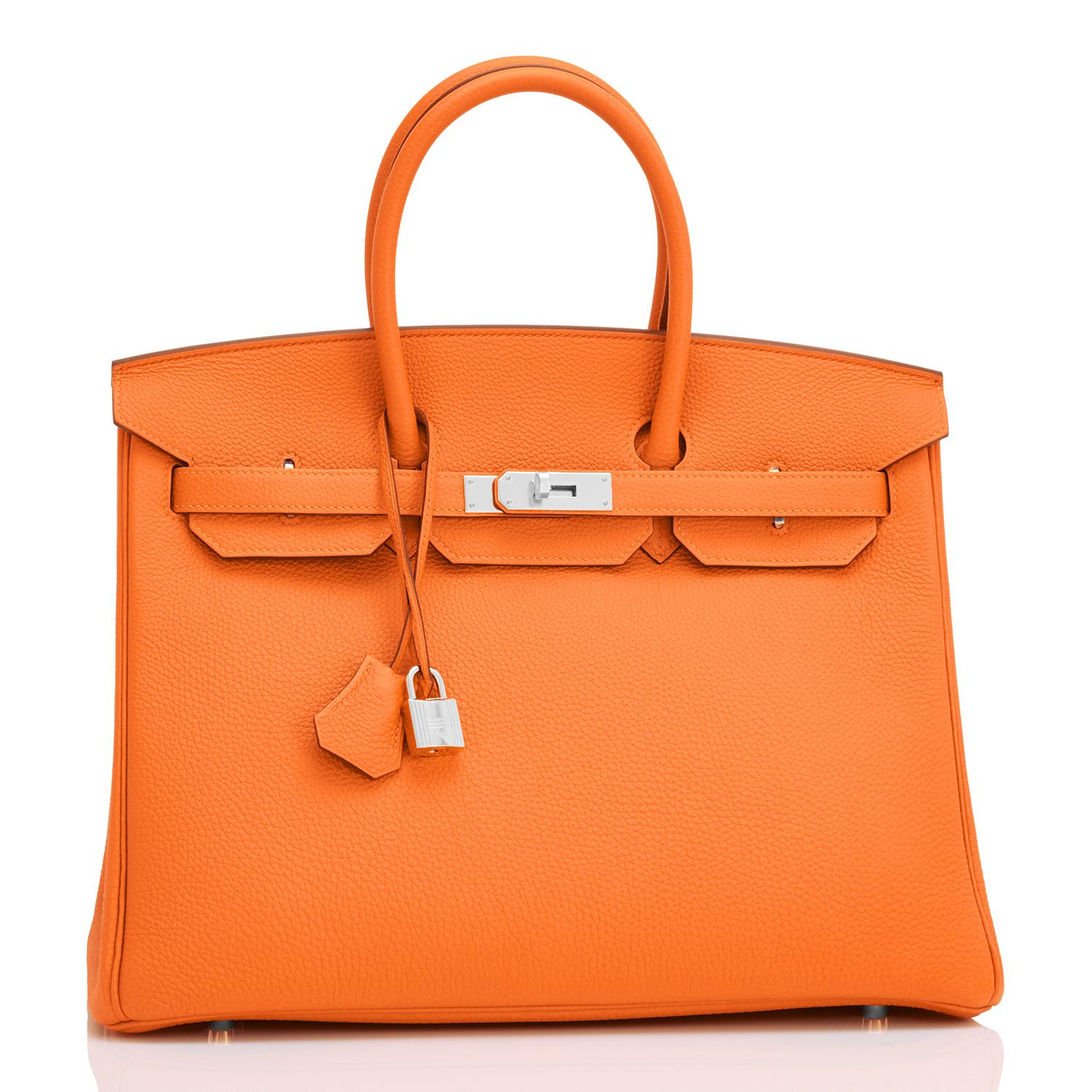 Hermes Classic Orange Togo 35cm Birkin Bag Palladium Hardware 
Extremely rare find in New or Never Worn condition (with plastic on hardware). 
Comes in full set with lock, keys, clochette, sleeper, raincoat, and Hermes box. 
This is the highly