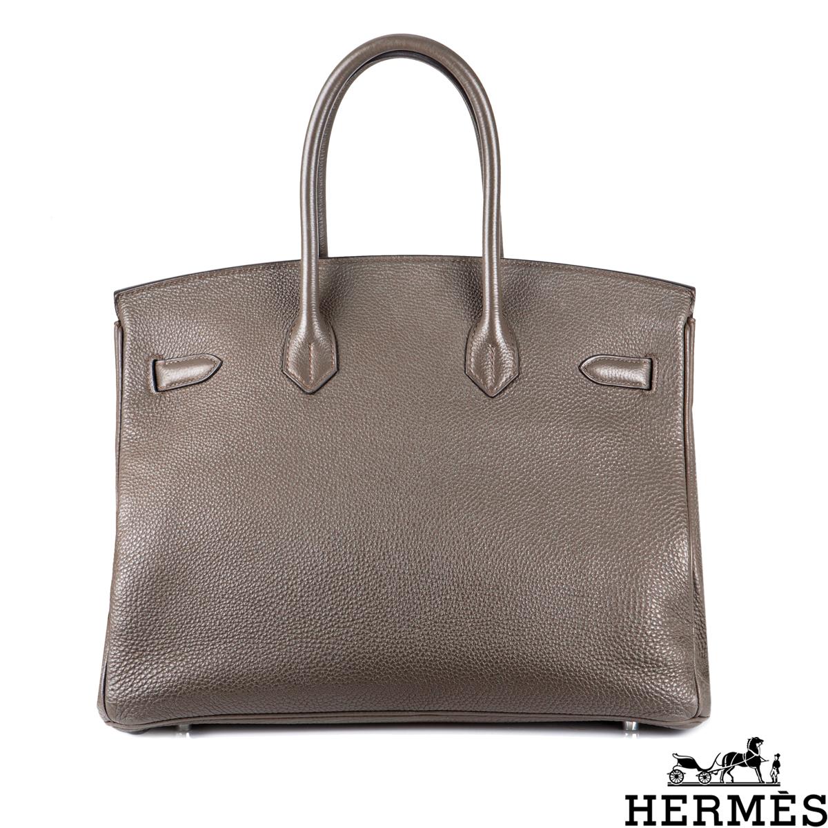 A classic Hermès 35cm Birkin bag. The exterior of this Birkin is in Etoupe Togo leather with tonal stitching. It features palladium hardware and two top handles with a front toggle closure. The interior features a zipper pocket with an Hermès