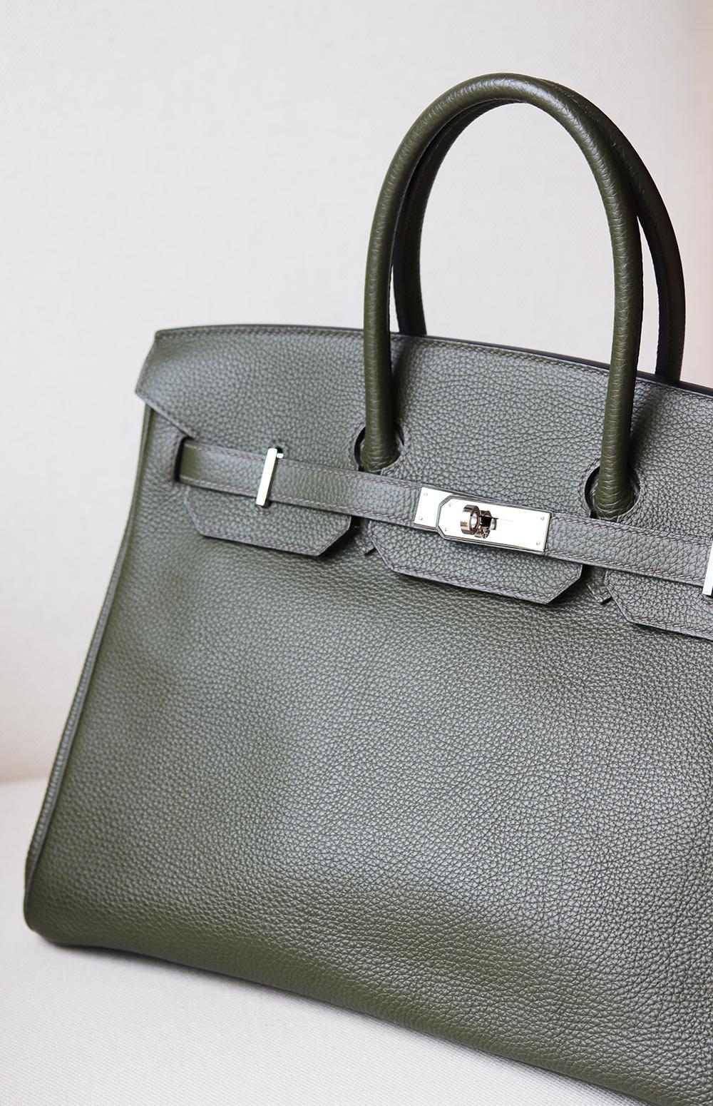 Hermès Birkin 35cm Togo-Leather Bag with Palladium hardware.
Top handle strap.
Tonal leather lining.
Double slit pocket and zip pocket on interior walls.
Turn-lock closure at front. 
Colour: Khaki (green).
Comes with all dustbag, lock and key and