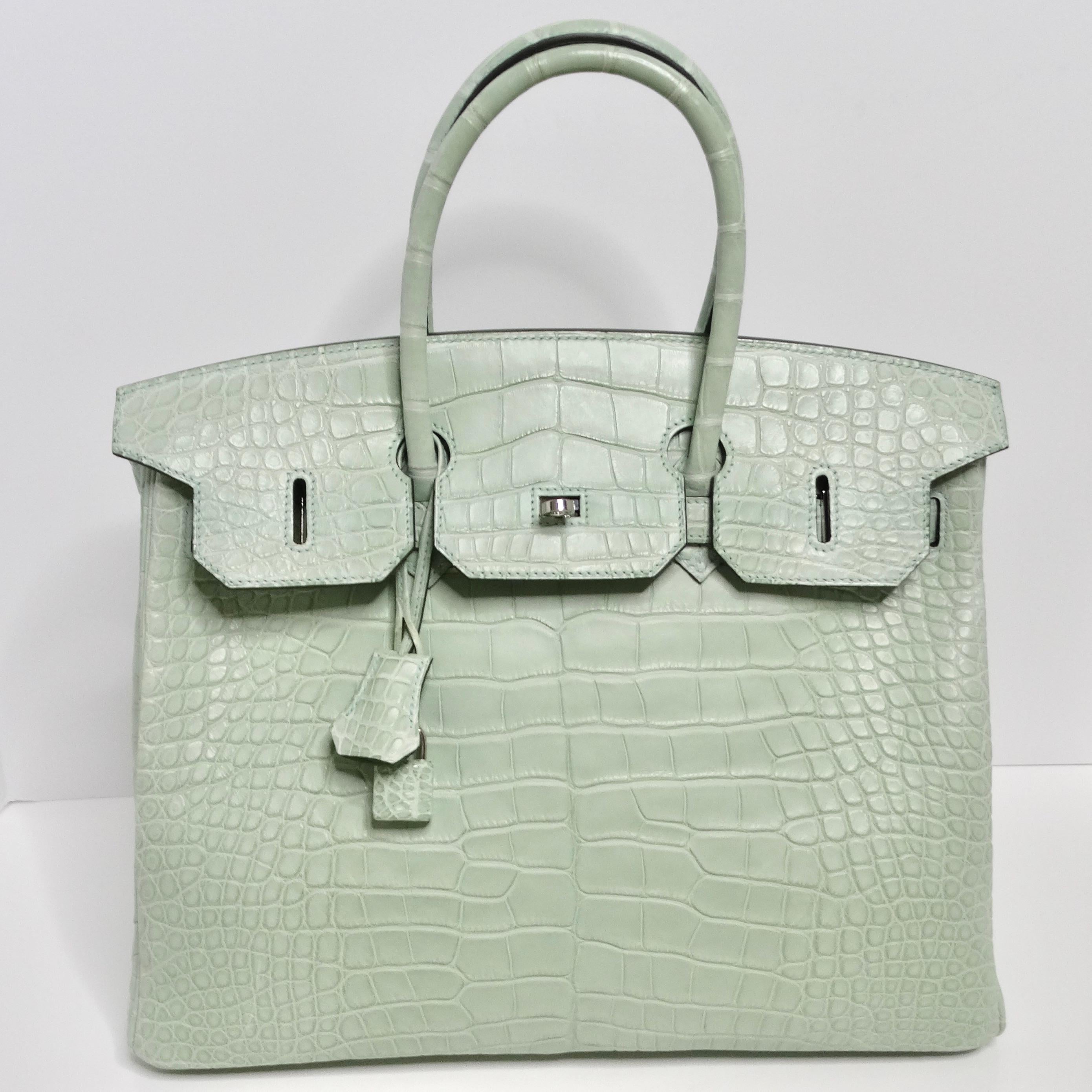 Introducing the epitome of luxury and sophistication, the Hermes Birkin 35 Vert D'Eau Matte Alligator Palladium Hardware handbag. Crafted in 2021, this iconic handbag is a testament to Hermes' impeccable craftsmanship and timeless design.

This