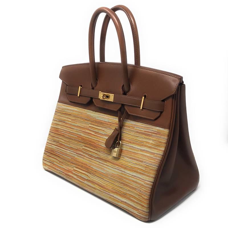 This rare handbag is constructed of a cross-section of multicolored strips of goatskin suede leather combined with polished calfskin in brown making it a very special Hermes bag.

It features rolled top handles, a frontal flap with a strap closure,