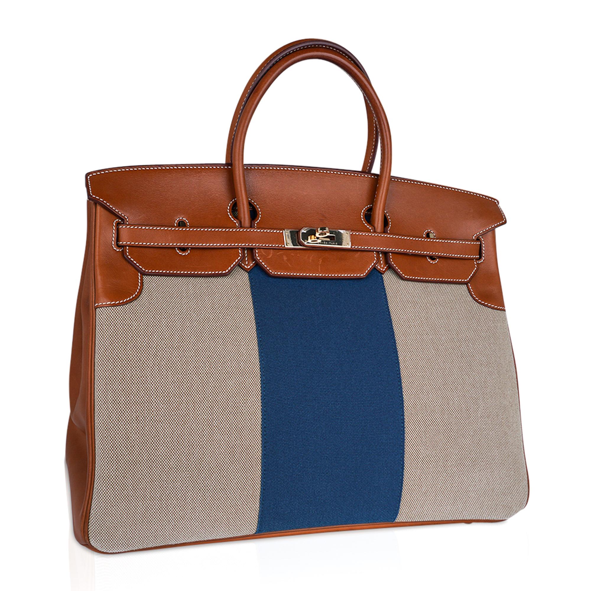 Mightchic offers a rare limited edition Hermes Birkin 40 Flag bag. 
Criss Cross toile with Blue center stripe. 
Fauve Barenia leather with signature bone topstitch.
Permabrass hardware.
Plastic on hardware.
Light marking on Barenia flap.
Comes with