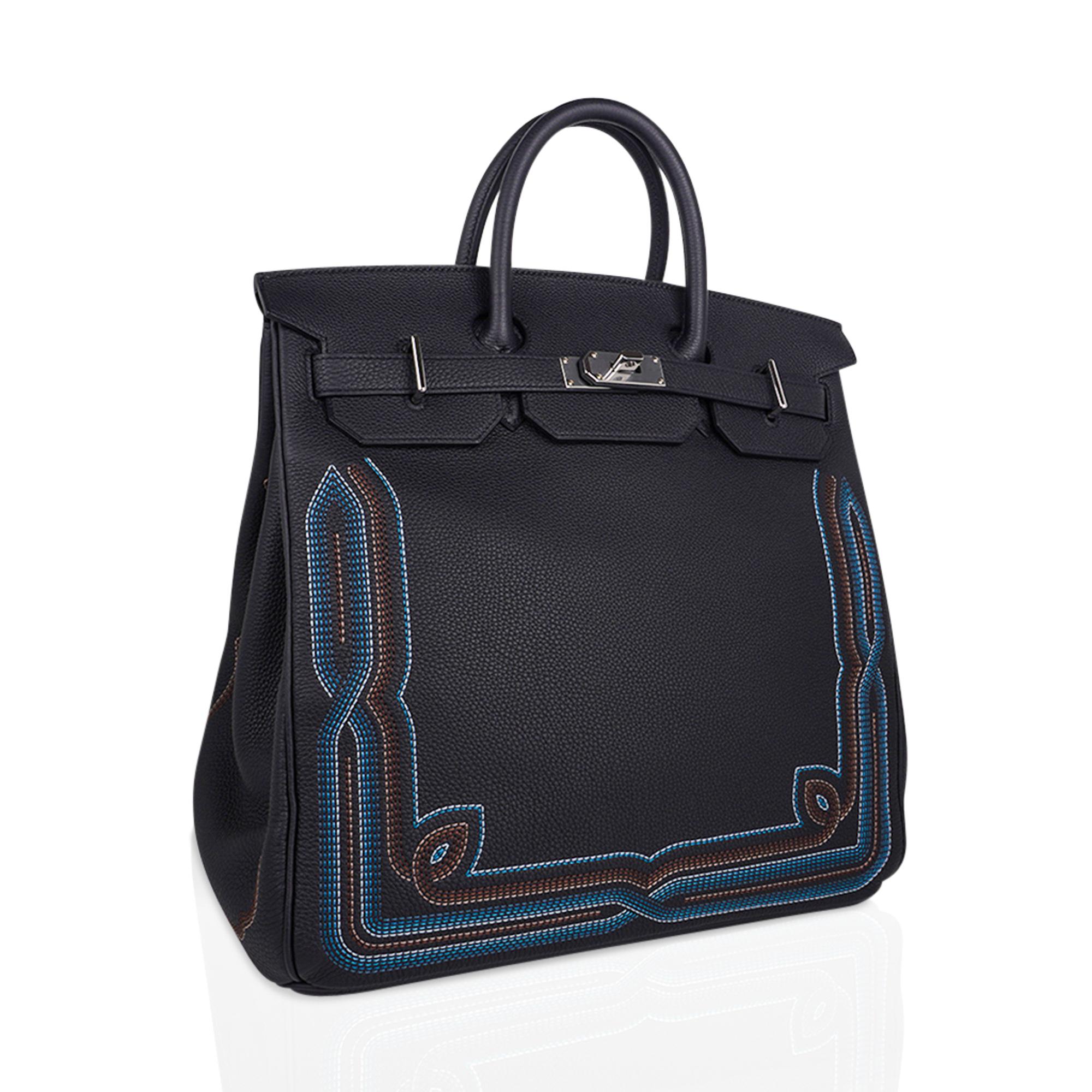 Mightychic offers a  Limited Edition Hermes Runway Haut a Courroies or HAC bag is featured in Black with gorgeous embroidery detail.
Black Togo leather accentuates the Blue and Camel western influenced embroidery  in the front and rear..