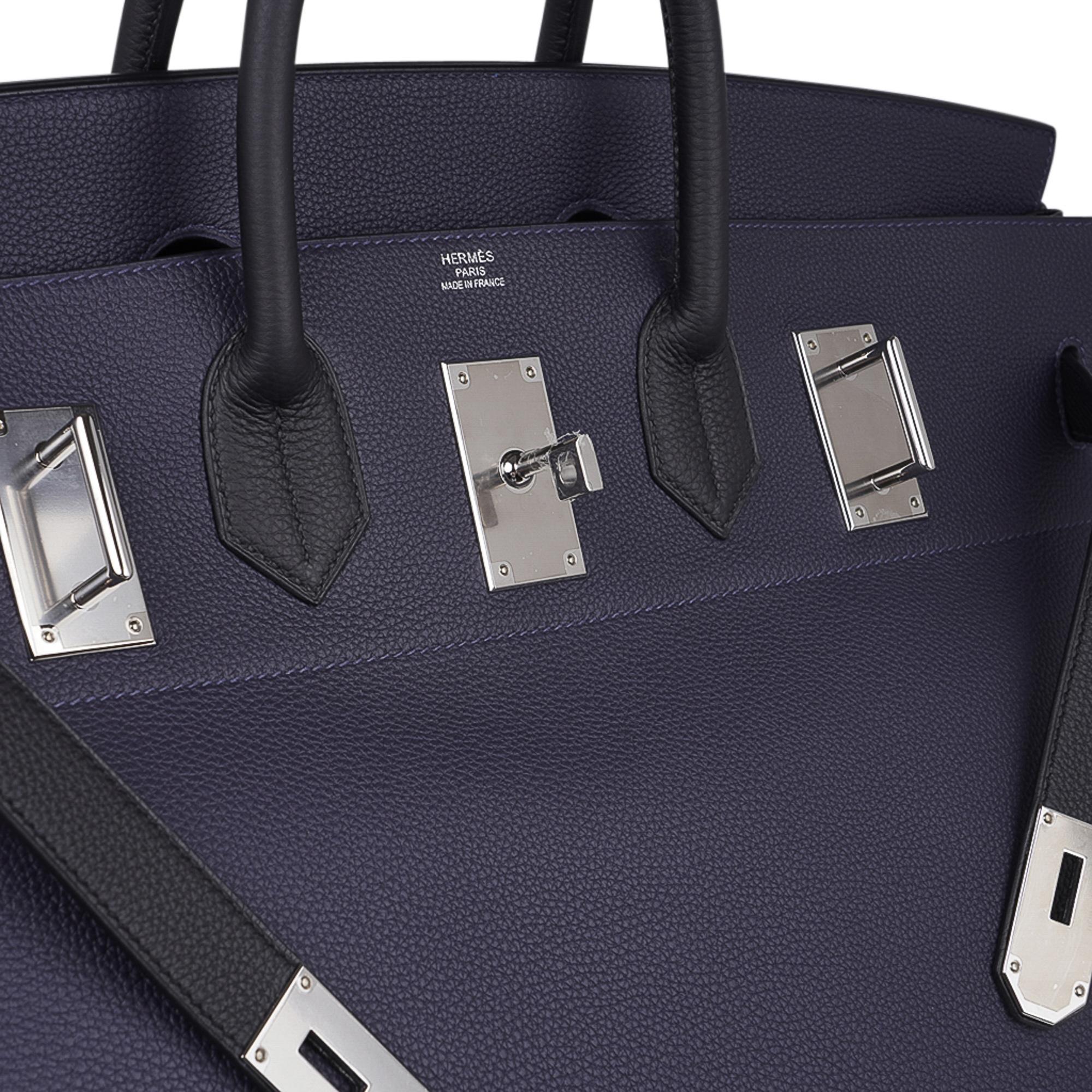 Mightychic offers a very rare Bi-color Hermes Hac  50 bag - Sac Haut a Courroies - featured in Blue Nuit and Black.  
Beautiful sophisticated combination with Palladium hardware.  
Togo leather is highly scratch resistant. 
This beautiful travel bag