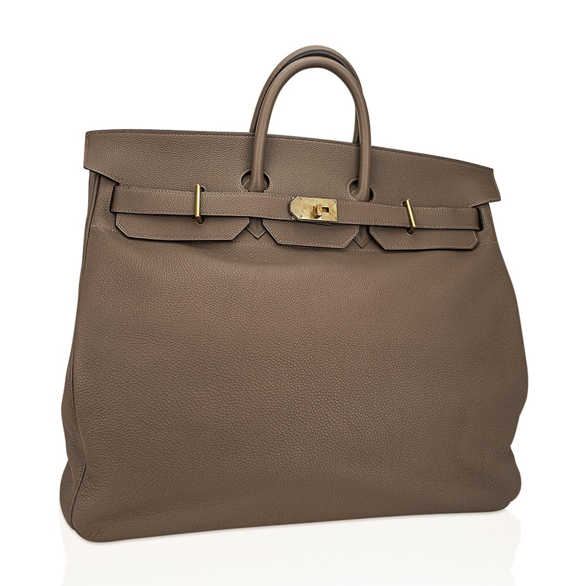 Mightychic offers a rare Hermes HAC 50 bag featured in Etoupe. 
Accentuated with Brass hardware.
Comes with lock, keys and clochette.
The HAC (Haut à Courroies) is an extremely rare and especially stylish Hermes travel bag making it a collector’s