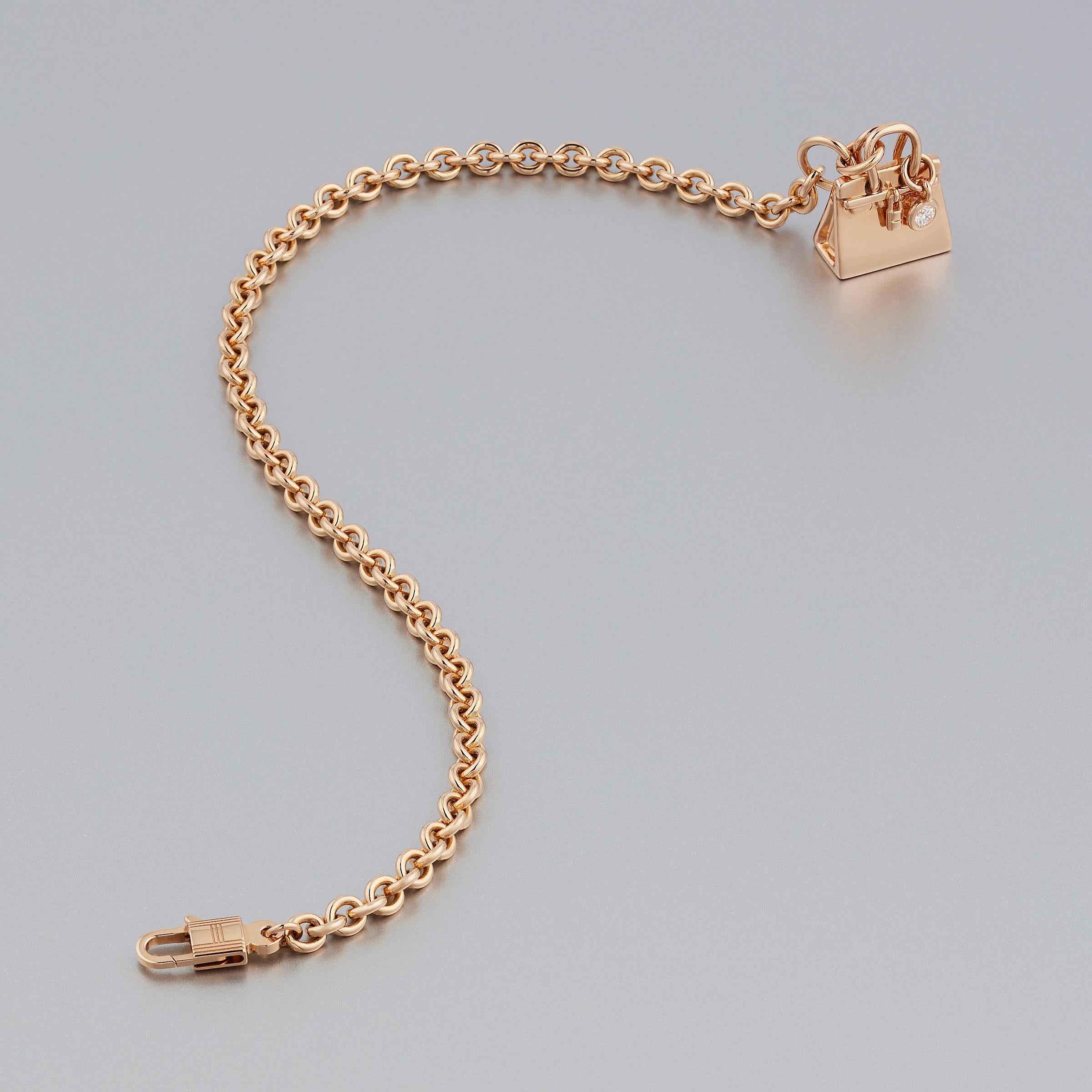 Stylish Hermes Birkin Amulette diamond bracelet in 18 karat gold. This delicate chain bracelet is part of Hermes popular Amulettes collection and features a delightful Birking bag shaped charm. The bracelet glows with radiance of high-polish rose