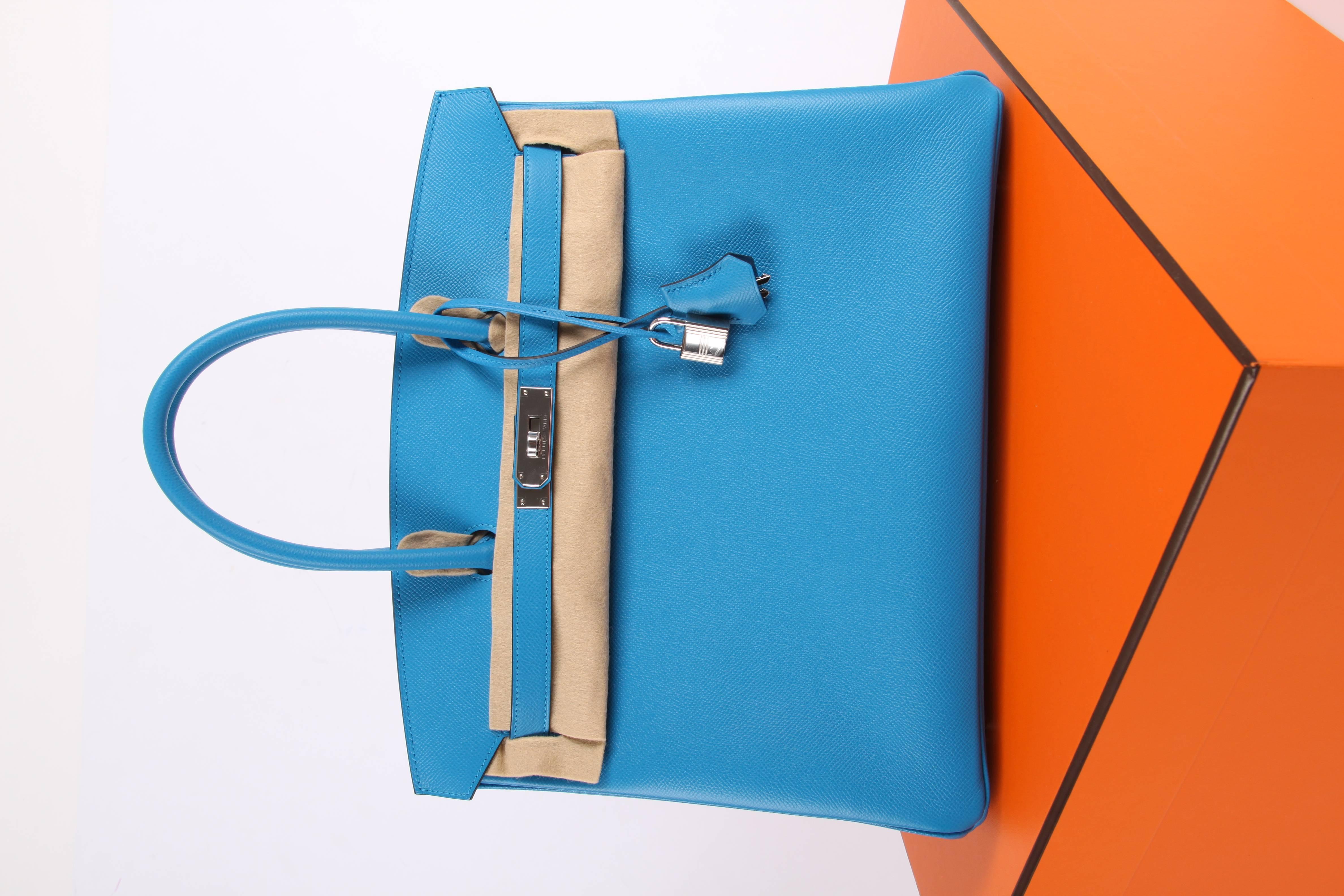 This one stands out!! Hermès Birkin Bag 35 crafted of Epsom leather with palladium hardware, this color is named Bleu Zanzibar. The nicest shade of bright blue you can imagine. New new new!

Front toggle closure, clochette with silver-tone lock and