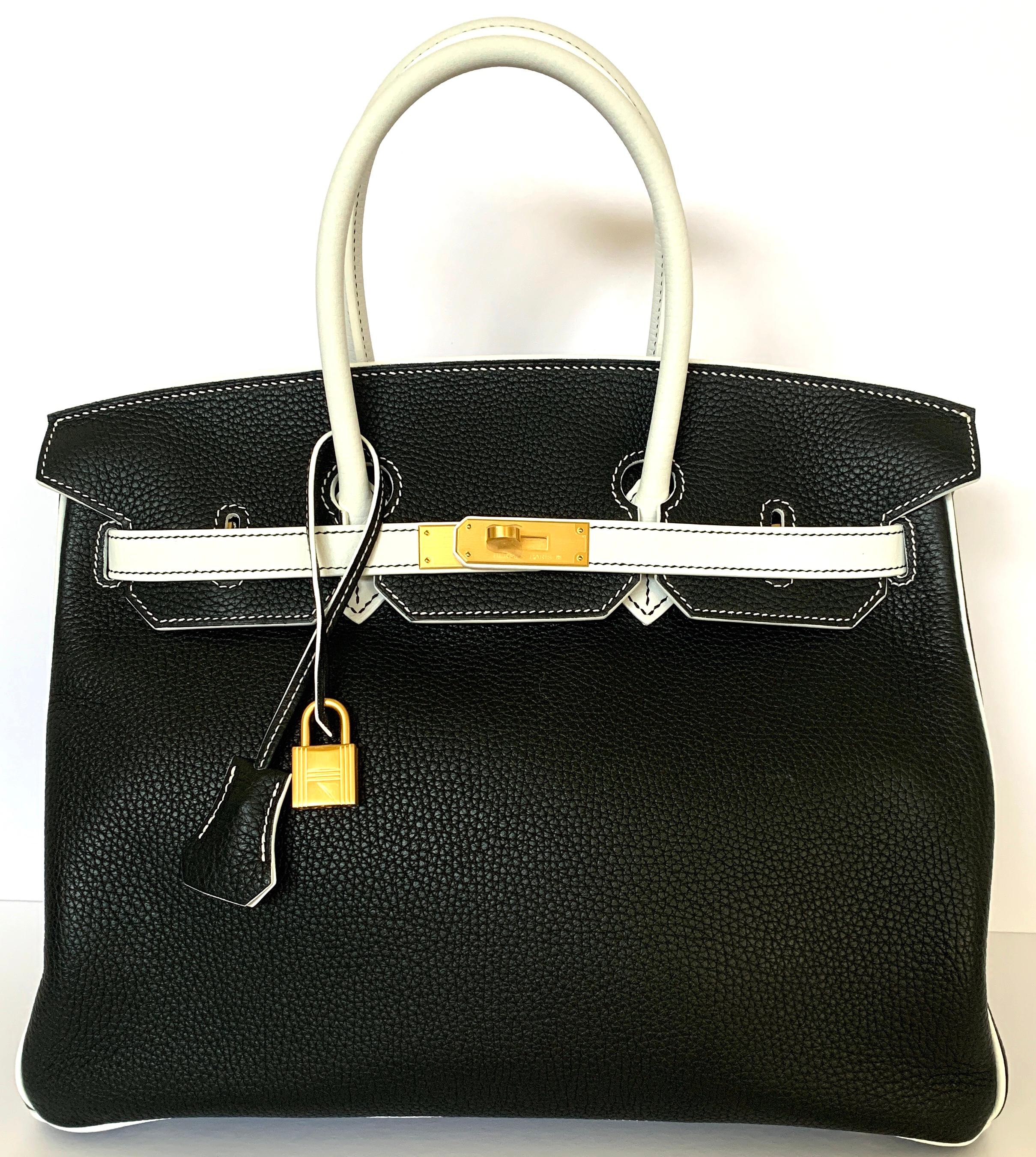 Hermes 35cm Birkin
Specially ordered for VIP
ABSOLUTLEY STUNNING
Black and White Clemence Leather
Notice the contrasting top stitching details
Brushed Gold Hardware, making it a real stand out in a crowd
Interior pocket
Lock and 2 keys
Hermes Box,