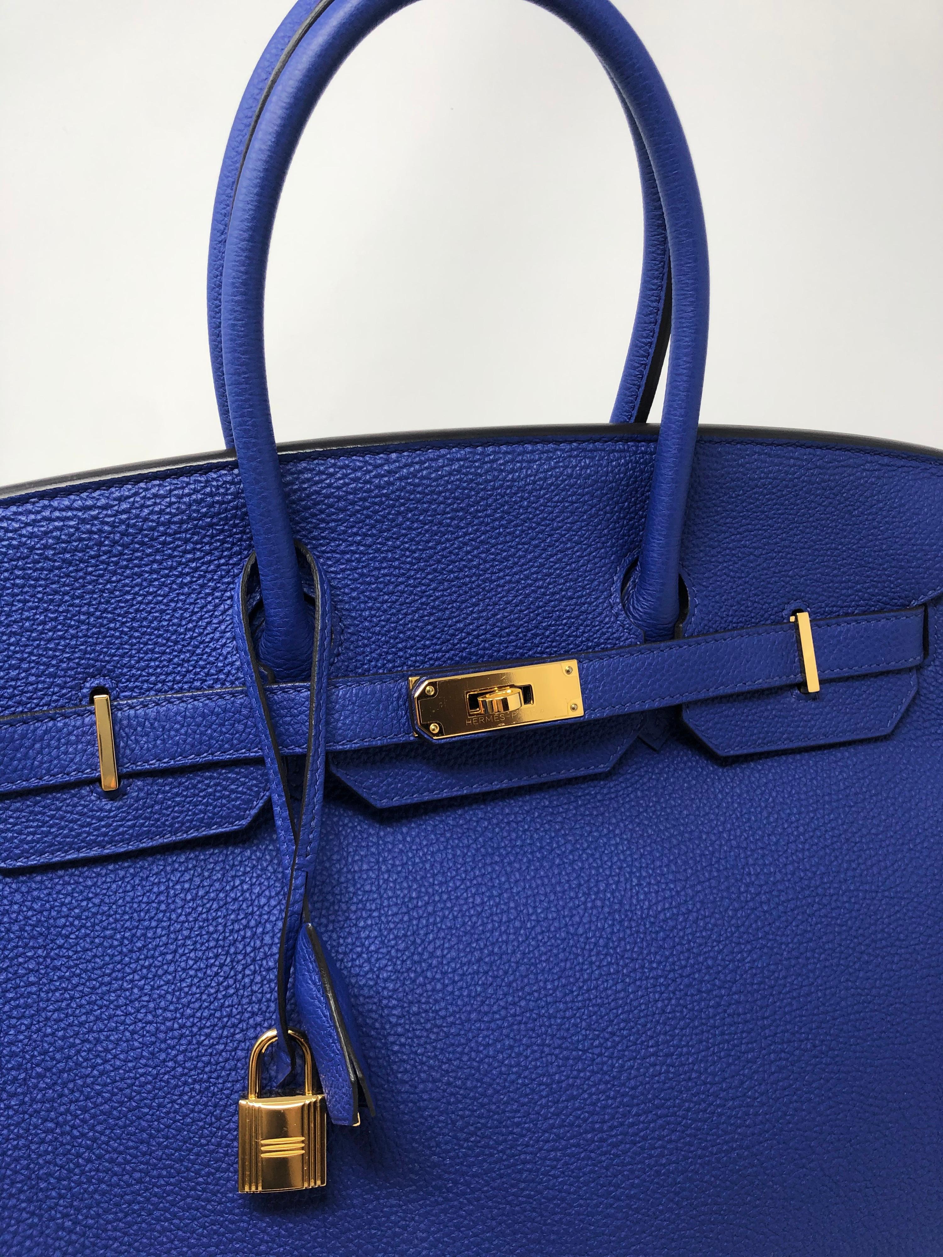 Hermes Bleu Electrique Birkin 35 Togo leather with gold hardware. Absolutely gorgeous. Hard to find color with gold hardware. Mint condition. Looks new. Plastic covering is still on hardware. Full set with box, dust cover, clochette and keys. Don't