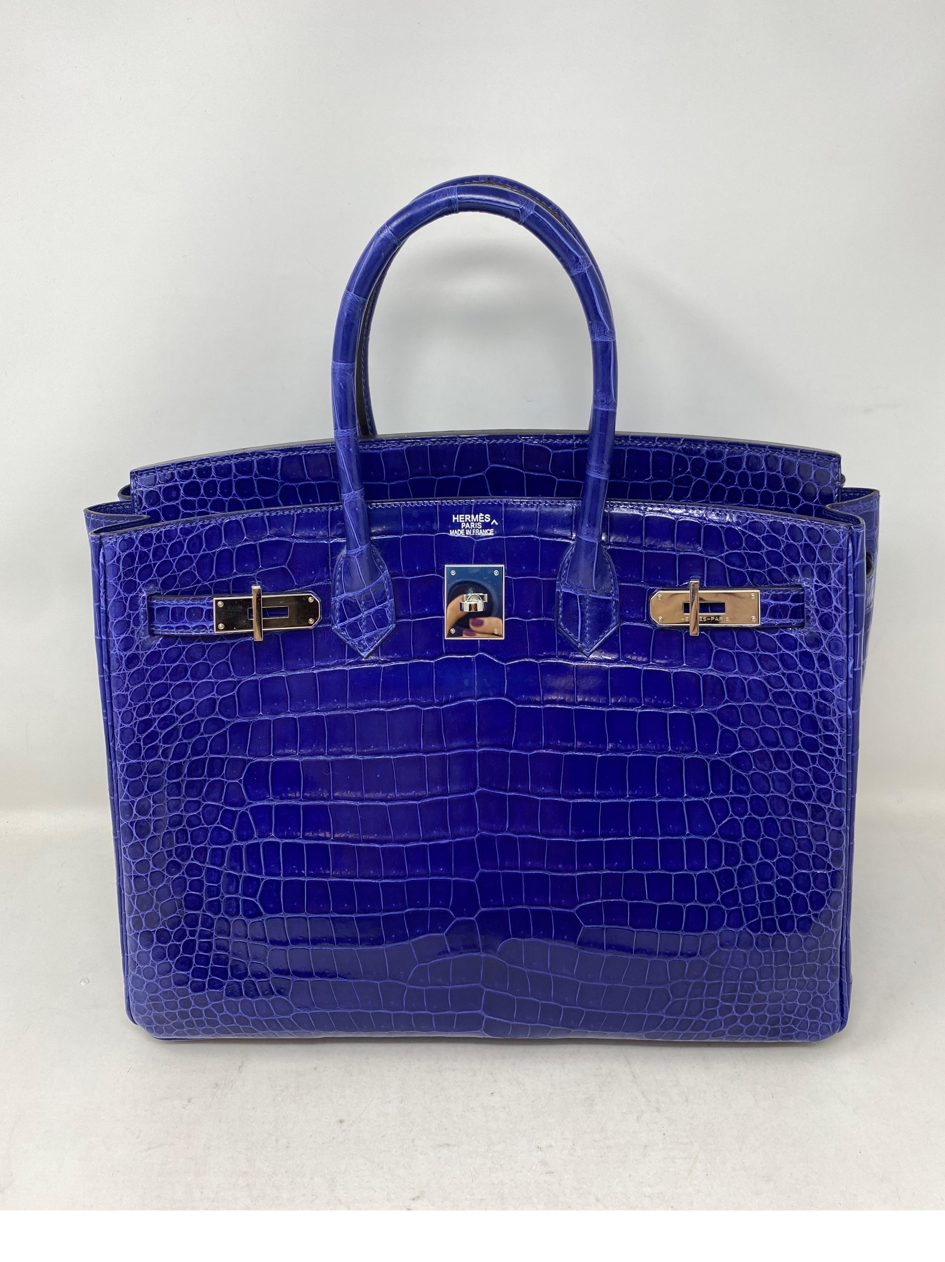 Hermes Blue Electrique Crocodile Birkin 35 Bag. Excellent like new condition. Stunning and rare blue color. Palladium hardware. Collector's piece. Investment bag. Includes original receipt, Cites paperwork. Includes clochette, lock, key, and dust