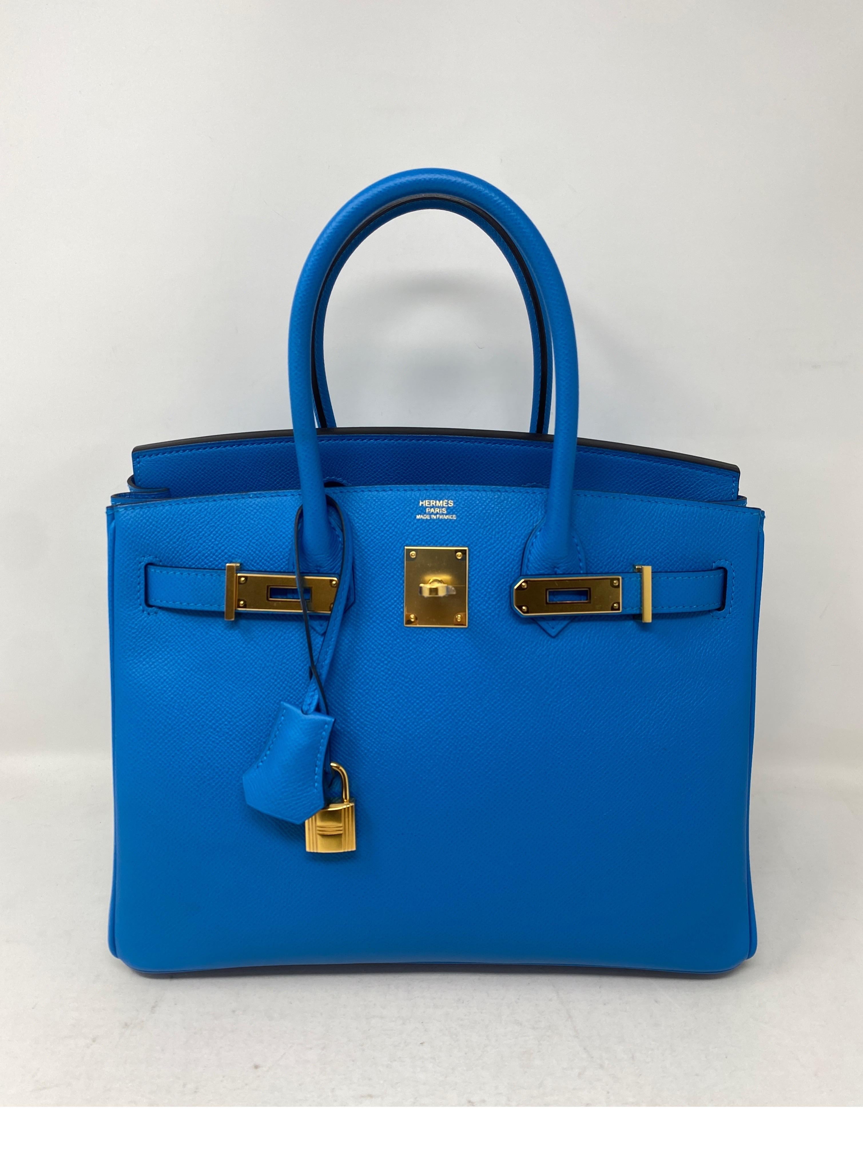 Hermes Blue Zanzibar Birkin 30 Bag. Vibrant rare blue color with gold hardware. Like new bag. Newer bag. Still has plastic on hardware. Don't miss out on this amazing color combo. Includes clochette, lock, keys, and dust cover. Guaranteed authentic. 