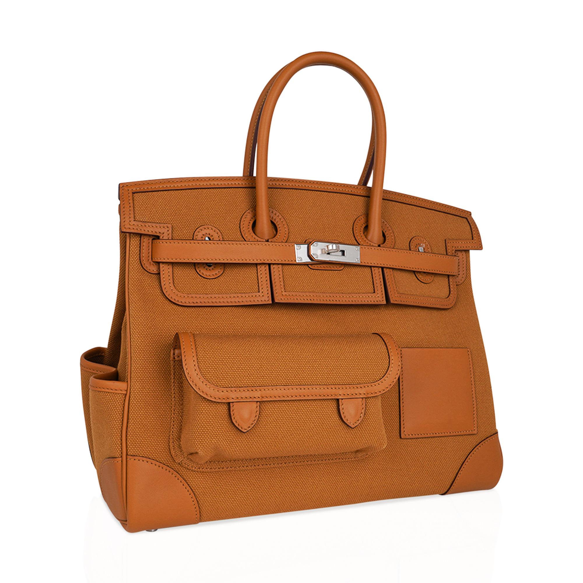 Mightychic offers an Hermes Cargo Birkin 35 bag featured in golden Sesame.
This Hermes limited edition utility Birkin bag is created with Goeland canvas and Swift leather trim.
Includes front and rear snap pockets, exterior credit card holder, a