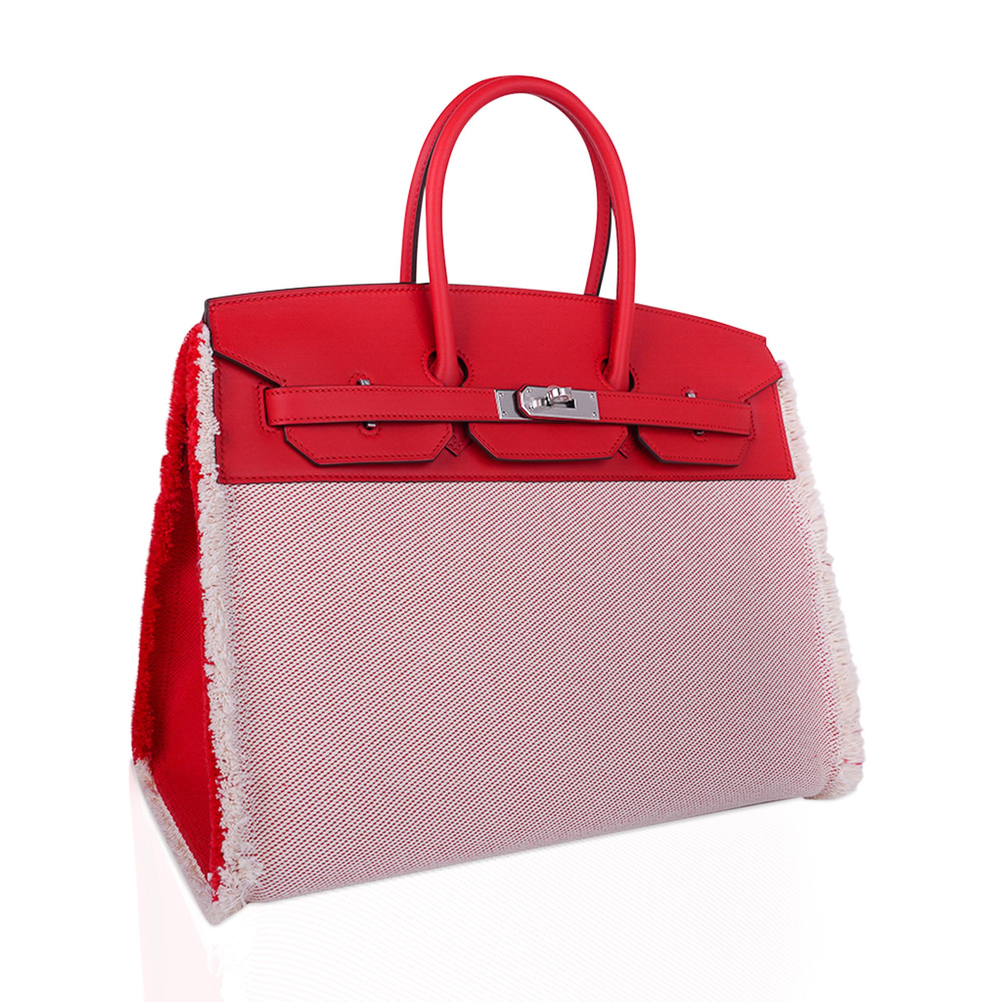 Mightychic offers an Hermes Birkin Fray Fray 35 Limited Edition bag featured in stunning Framboise.
Ecru and Framboise toile with frayed (fringe) edging.
The sides are Framboise toile.
Framboise Swift leather is crisp with the palladium