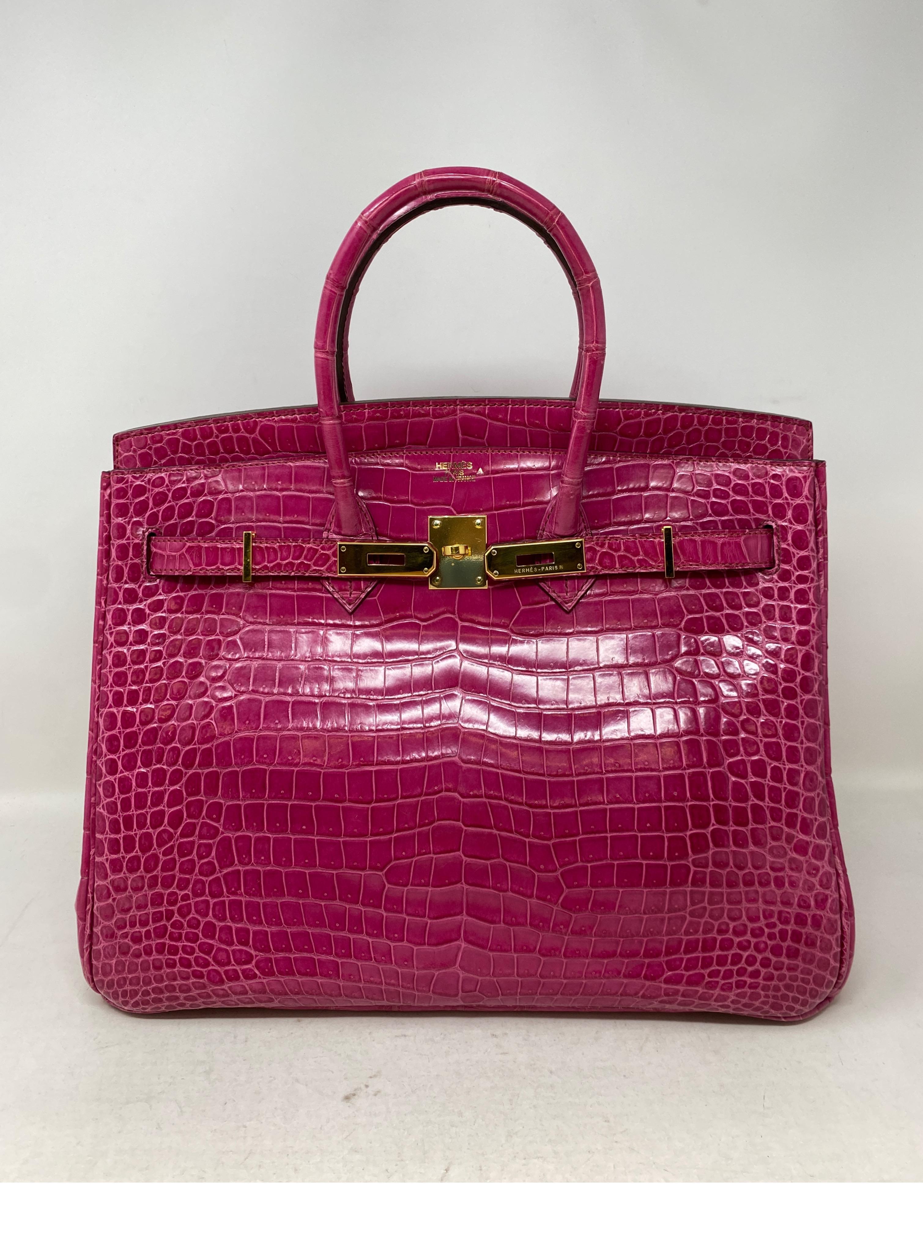 Hermes Fuschia Shiny Porosus Crocodile Birkin 35 Bag. Rare exotic crococodile bag. Gold hardware. Excellent condition. Like new. Interior is clean. all corners in excellent condition. Porosus crocodile is one of the most expensive exotics by Hermes.