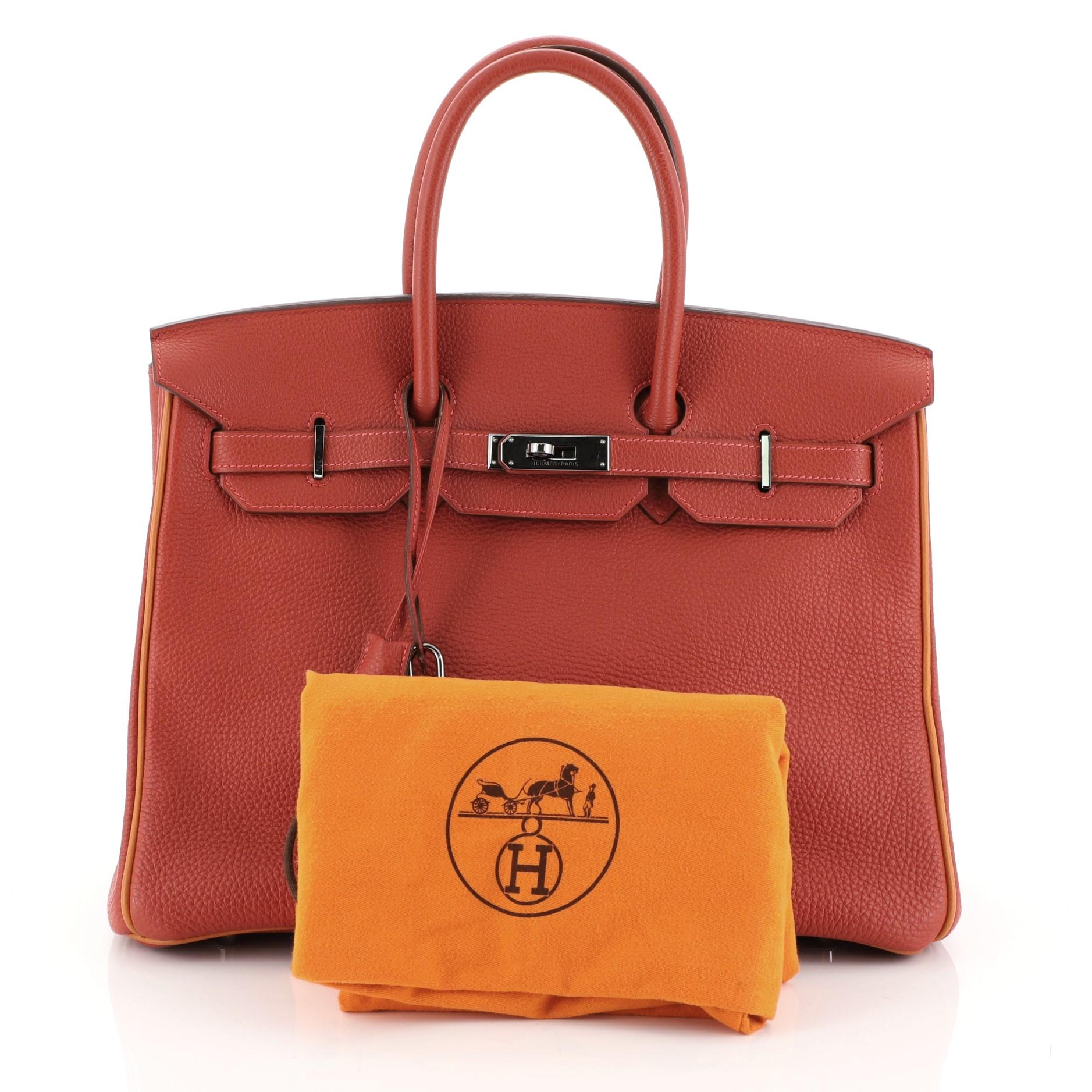 This Hermes Birkin Handbag Bicolor Togo with Ruthenium Hardware 35, crafted in Vermillion and Potiron Togo leather, features dual rolled handles, frontal flap, and ruthenium hardware. Its turn-lock closure opens to a Potiron Chevre leather interior