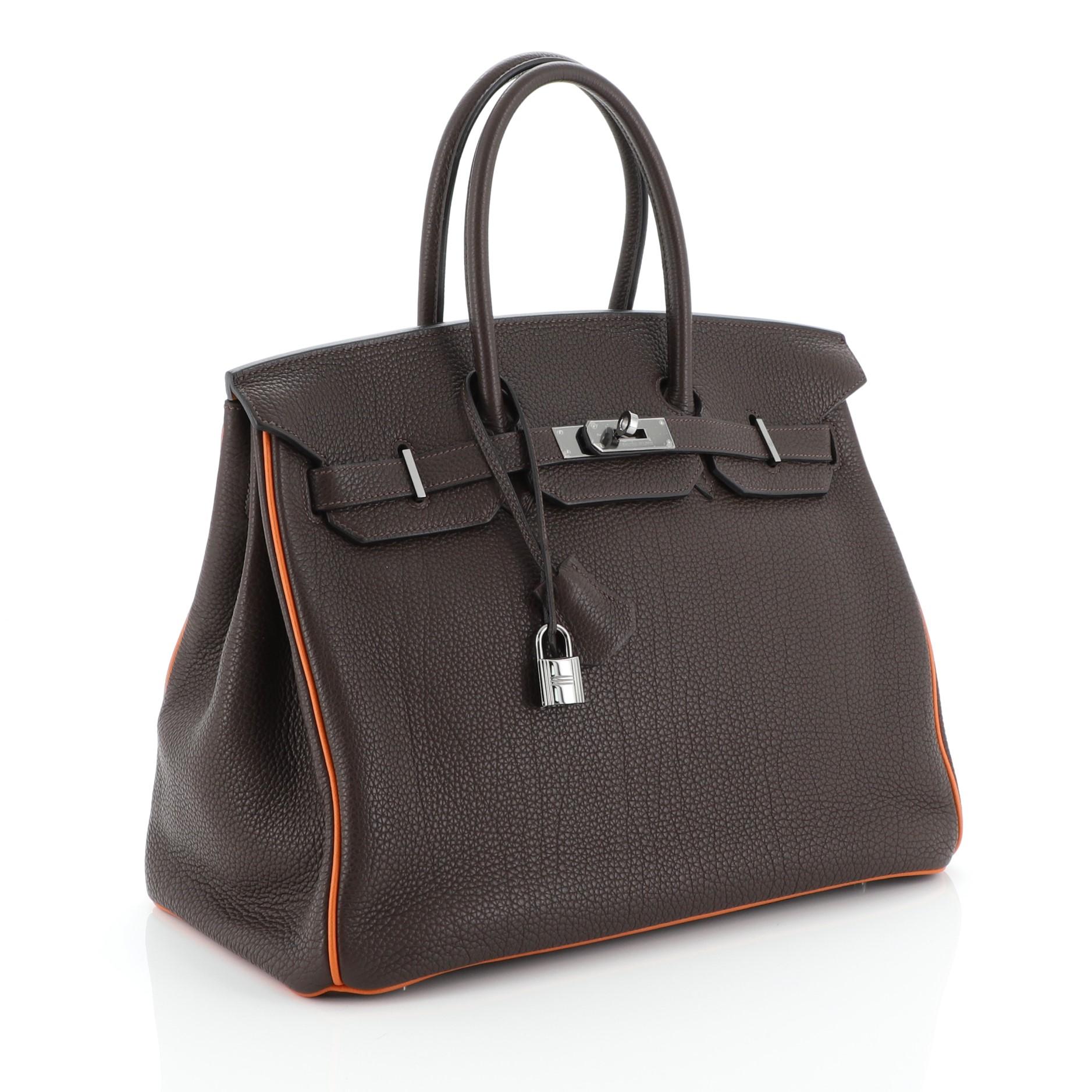 This Hermes Birkin Handbag Bicolor Togo with Ruthenium Hardware 35 is truly a classic piece, named after actress and singer Jane Birkin. Crafted in Chocolate brown Togo leather, this handbag features dual rolled top handles, frontal flap, and