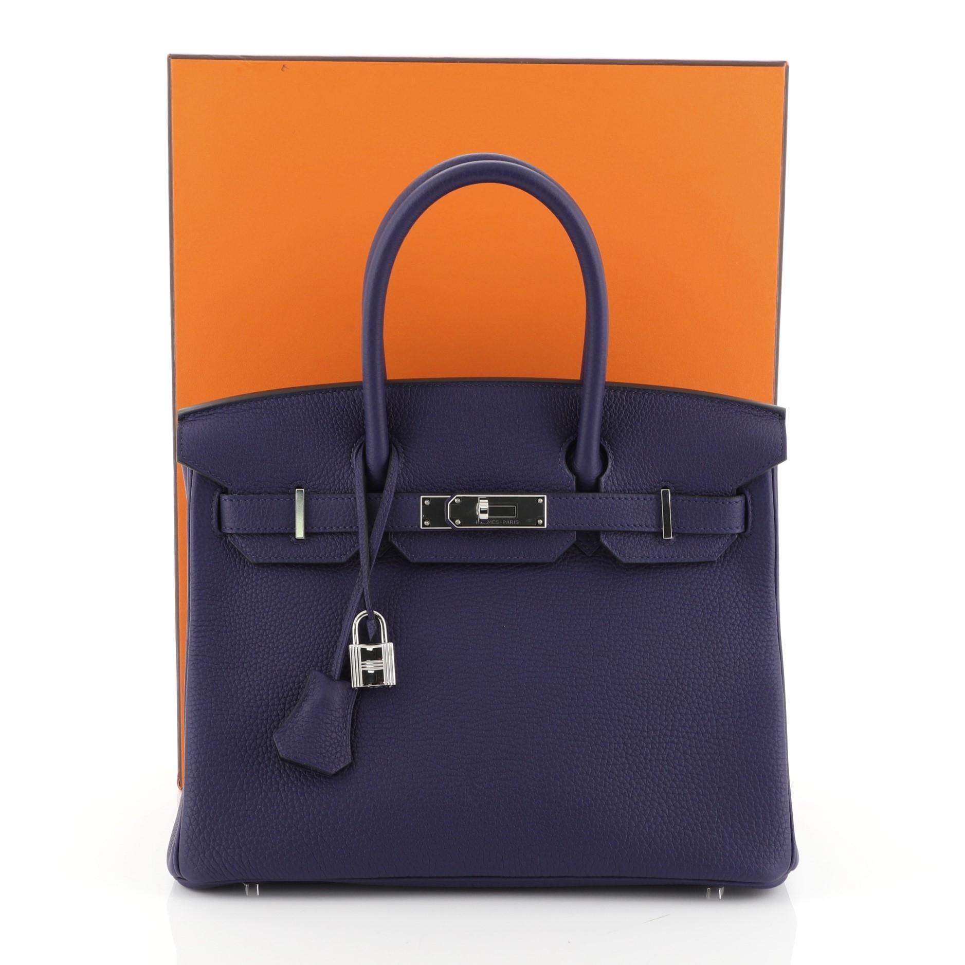 This Hermes Birkin Handbag Bleu Encre Togo with Palladium Hardware 30, crafted in Bleu Encre blue Togo leather, features dual rolled handles, frontal flap, and palladium hardware. Its turn-lock closure opens to a Bleu Encre blue Chevre leather