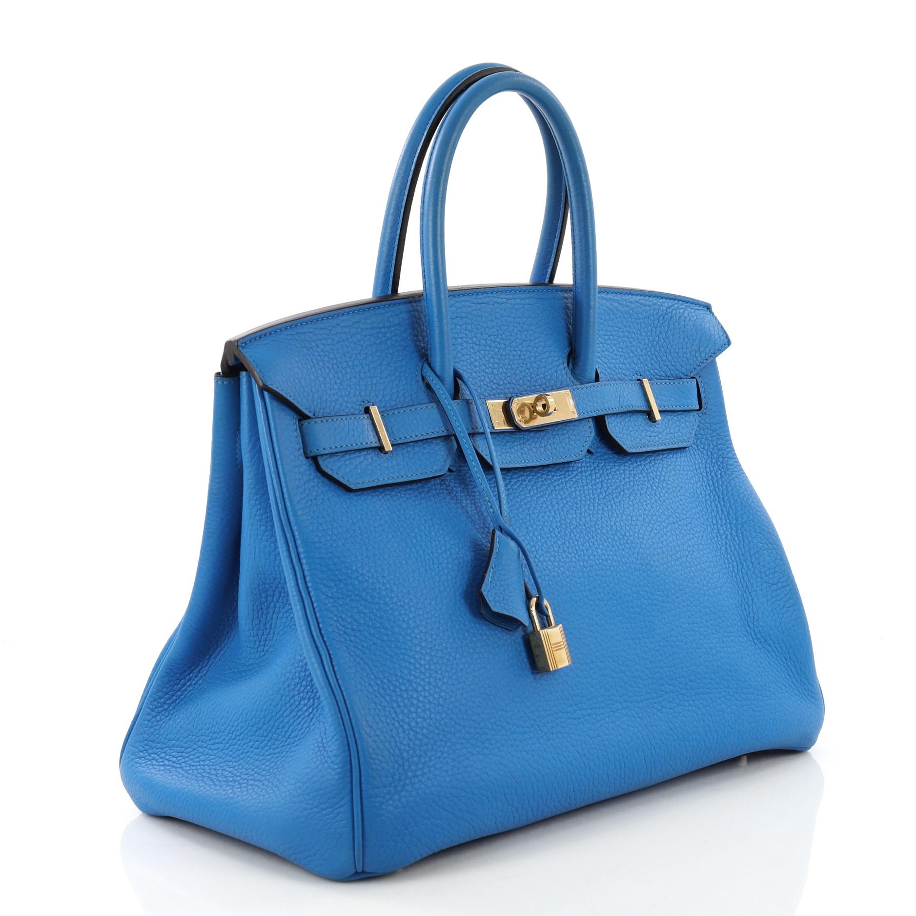 This Hermes Birkin Handbag Bleu Hydra Clemence with Gold Hardware 35, crafted in Bleu Hydra blue Clemence leather, features dual rolled handles, frontal flap, and gold hardware. Its turn-lock closure opens to a Bleu Hydra blue Chevre leather