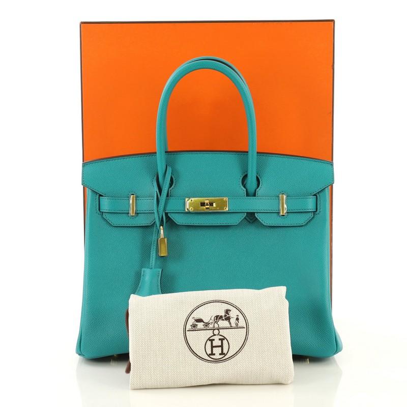 This Hermes Birkin Handbag Bleu Paon Epsom with Gold Hardware 30, crafted in Bleu Paon blue Epsom leather, features dual rolled top handles, frontal flap, and gold hardware. Its turn-lock closure opens to a Bleu Paon blue Chevre leather interior