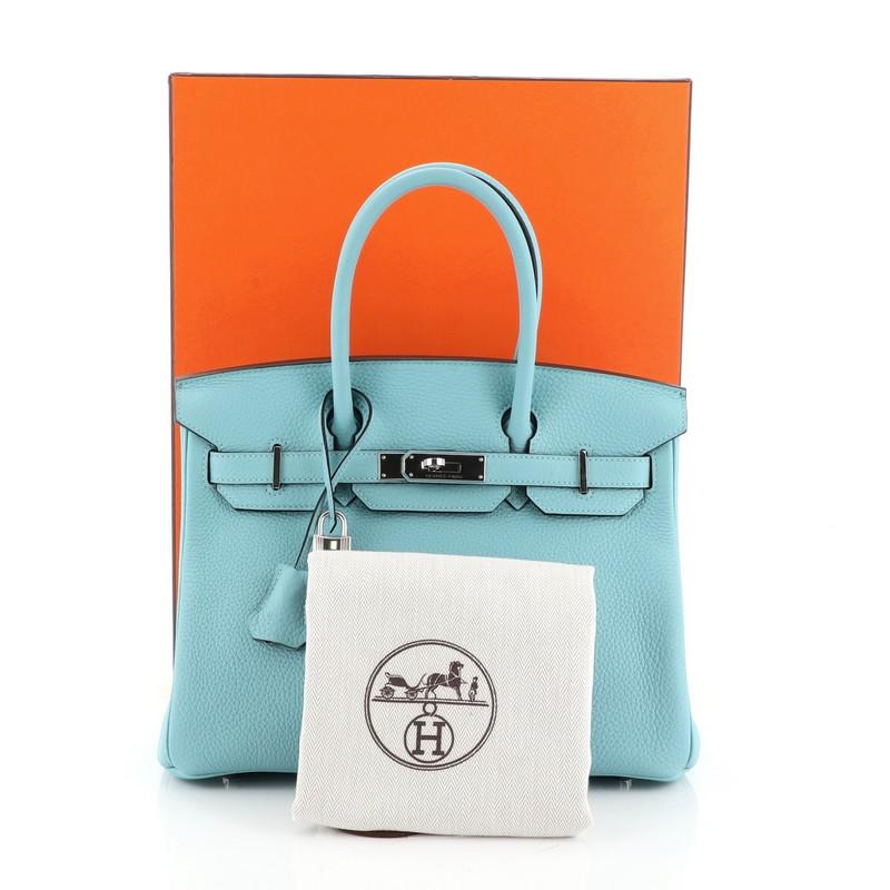 This Hermes Birkin Handbag Blue Atoll Clemence with Palladium Hardware 30, crafted in Blue Atoll blue Clemence leather, features dual rolled handles, frontal flap, and palladium hardware. Its turn-lock closure opens to a Blue Atoll blue Chevre