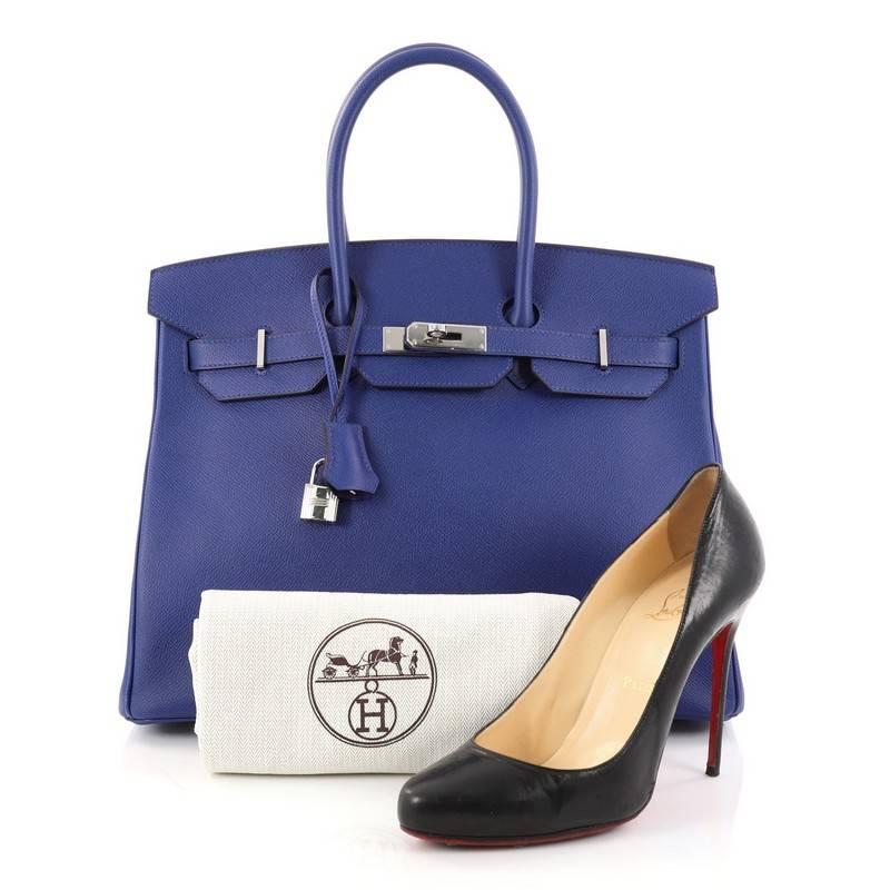 This authentic Hermes Birkin Handbag Blue Electric Epsom with Palladium Hardware 35 is a coveted accessory for avid Hermes lovers. Crafted in lightweight and scratch-resistant Blue Electric epsom leather, this bag features dual-rolled top handles,